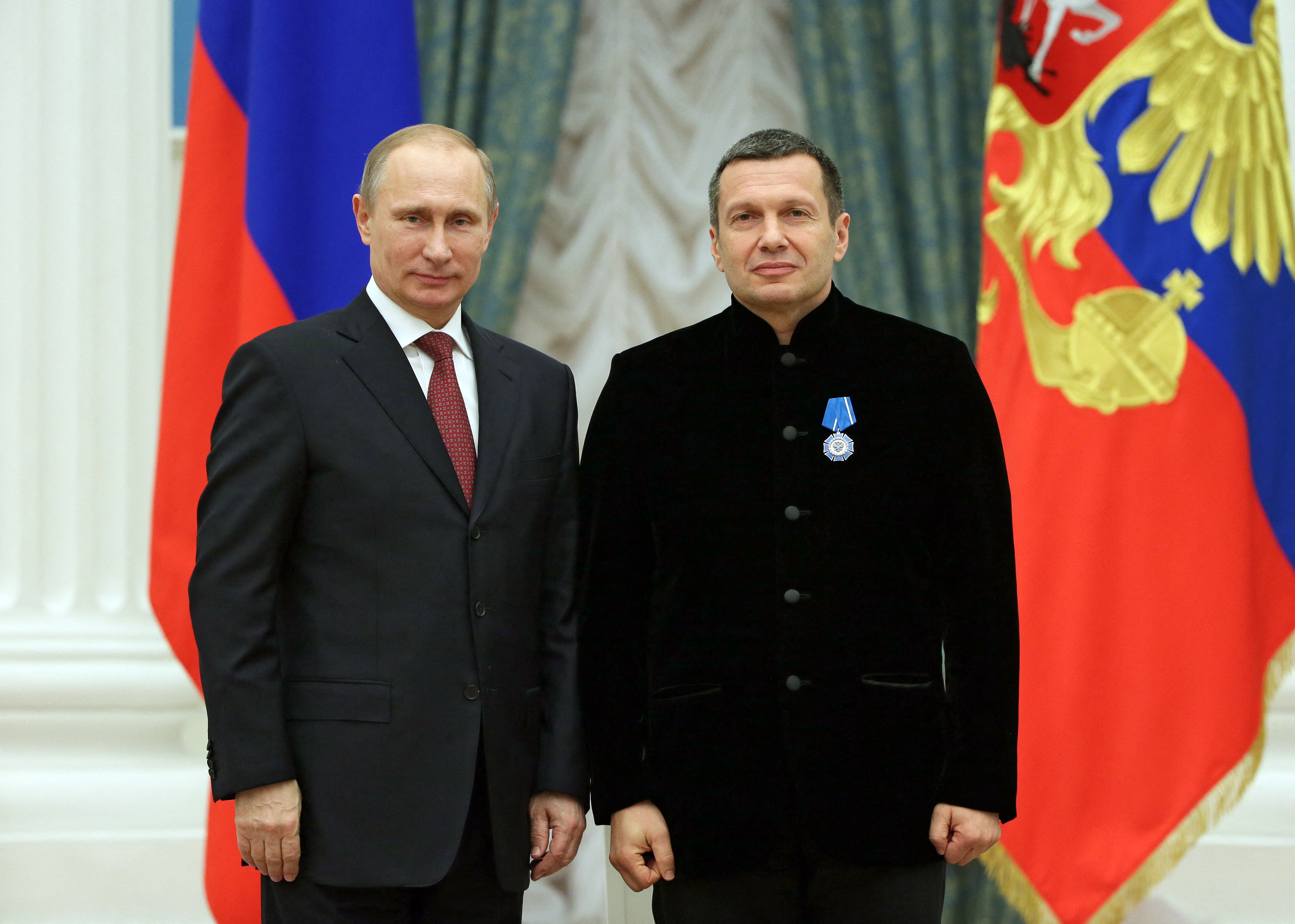 Russian President Vladimir Putin poses with TV anchor Vladimir Solovyev during an awards ceremony at the Kremlin in Moscow.