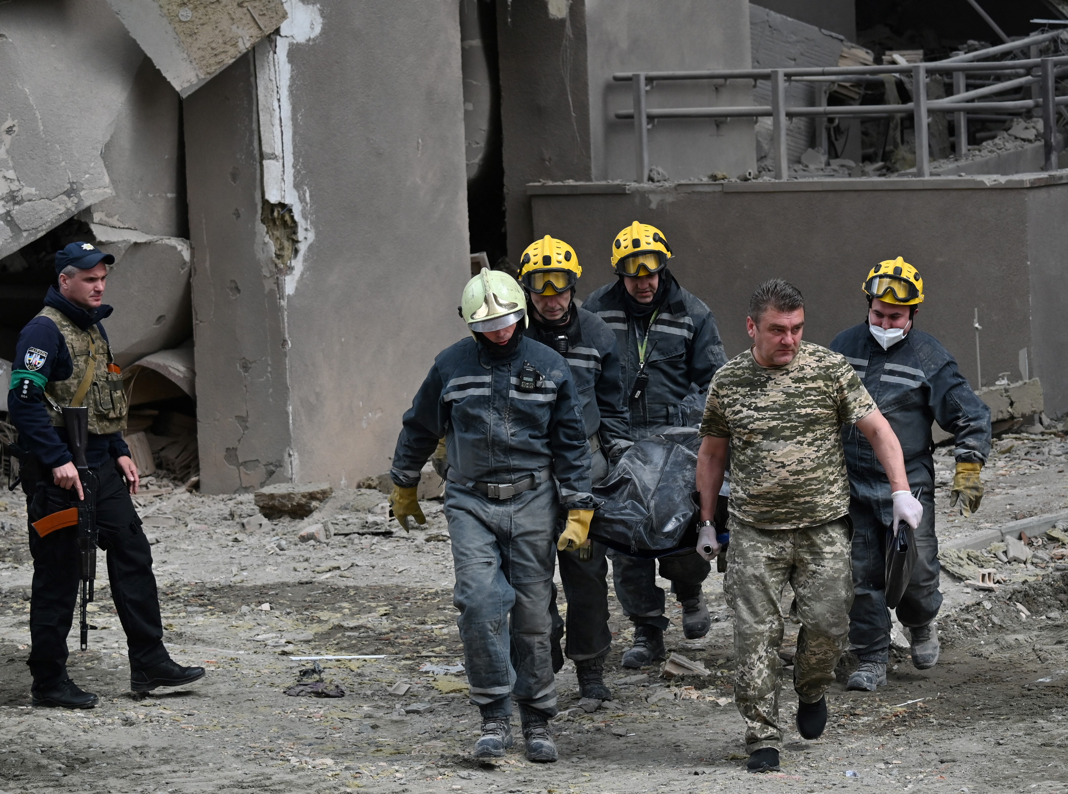 Rescuers carry a body from a damaged building following Russian strikes in Kyiv