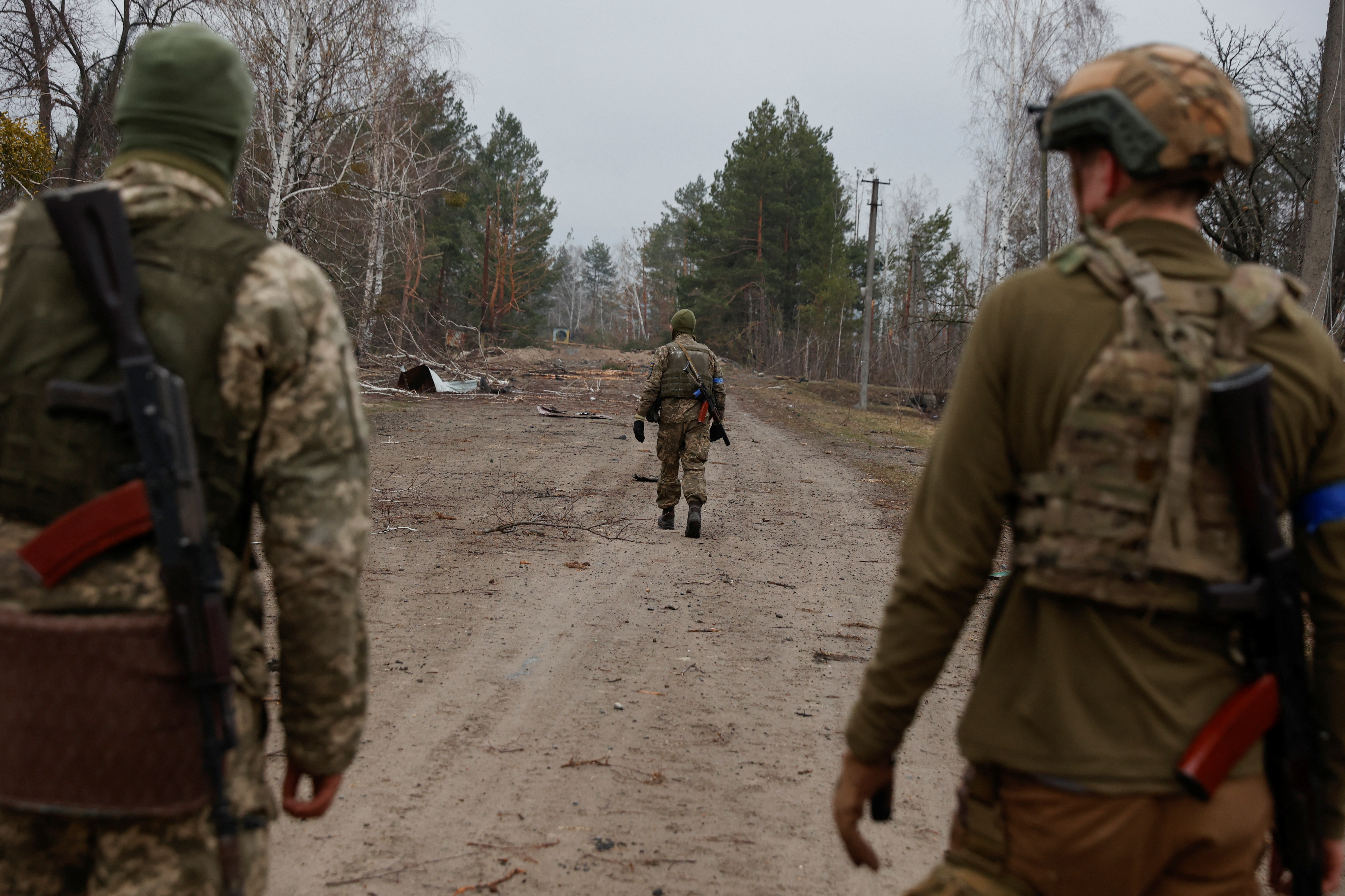 Ukrainian service members patrol an area in a village near a front line, as Russia’s attack on Ukraine continues, in Kyiv Region