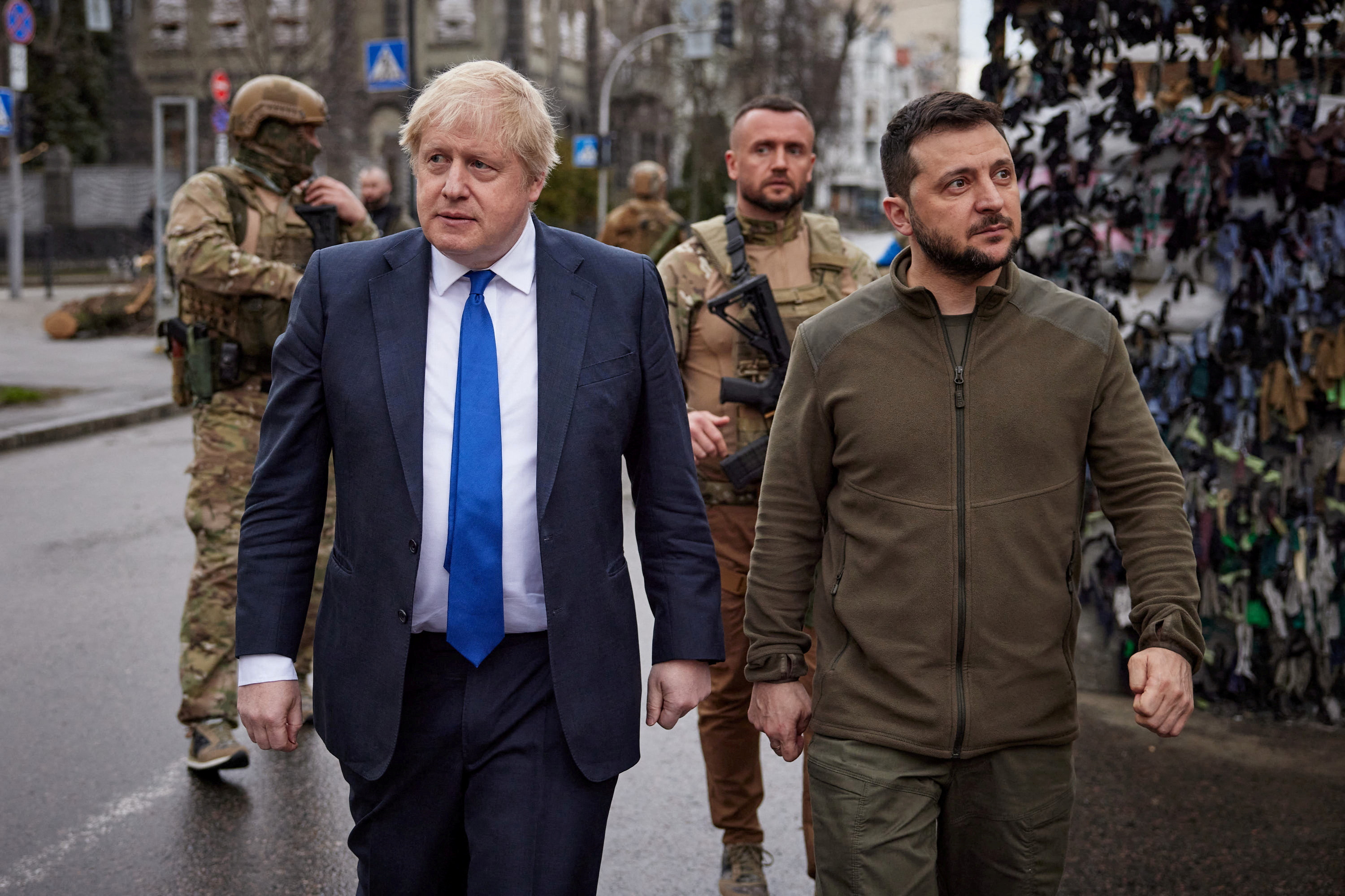 Ukraine’s President Volodymyr Zelenskyy and British Prime Minister Boris Johnson walk along a street after a meeting in Kyiv