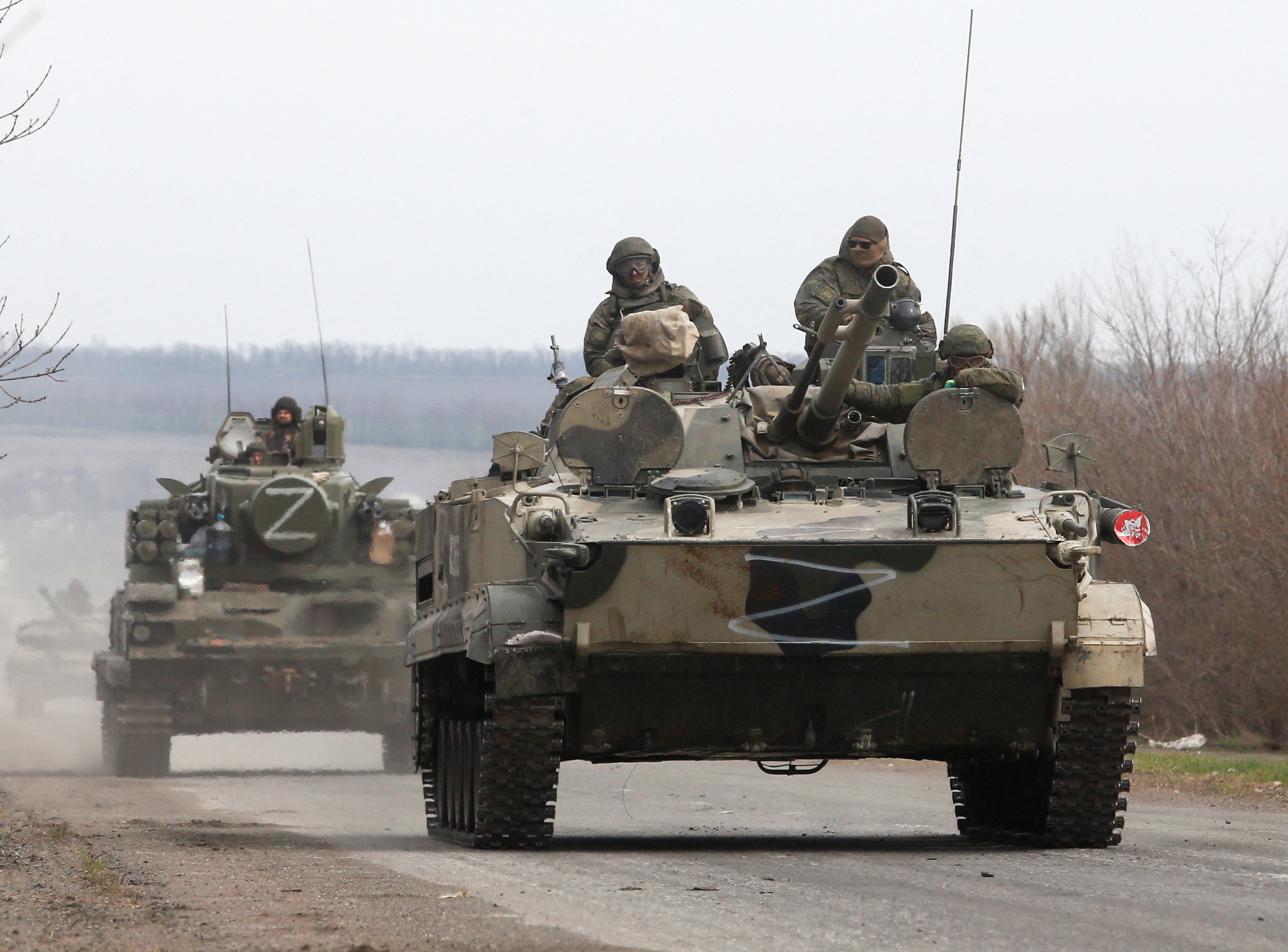 Service members of pro-Russian troops drive armoured vehicles during the Ukraine-Russia conflict on a road outside the southern port city of Mariupol, Ukraine on April 10, 2022