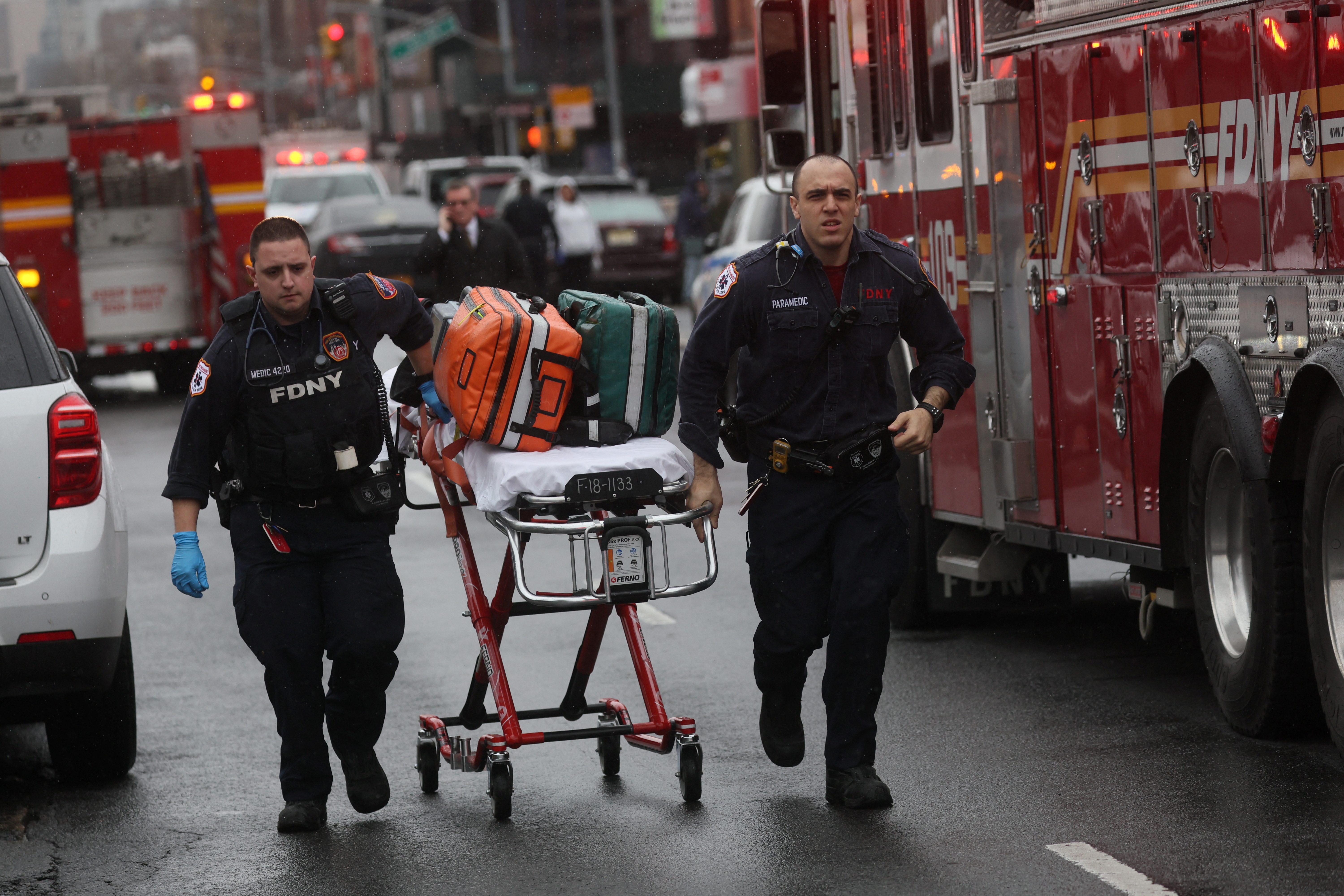 Emergency personnel work near the scene of a shooting at a subway station in the Brooklyn borough of New York City, US