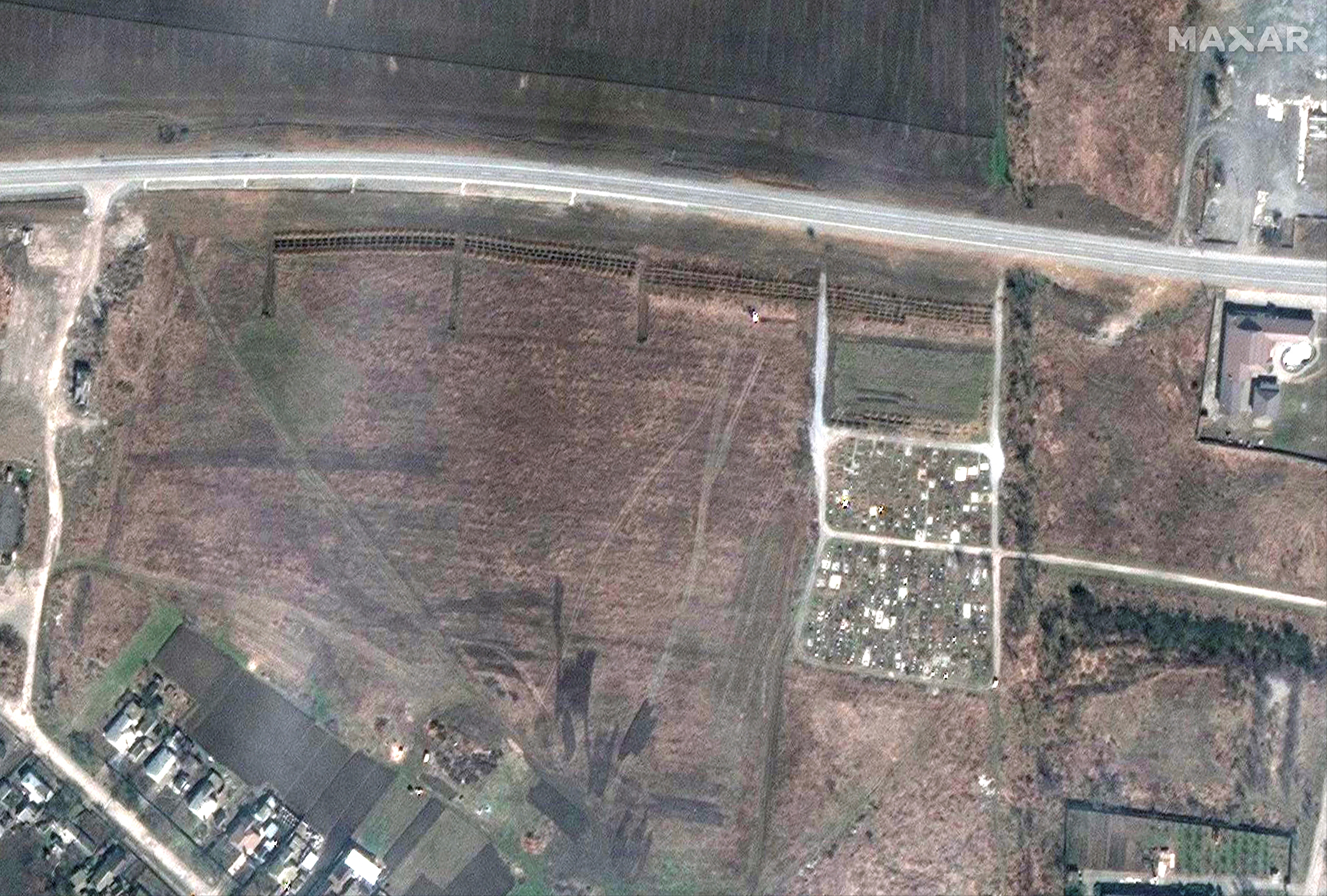 A satellite image shows an overview of a cemetery and the expansion of the new graves in Manhush, near Mariupol, Ukraine