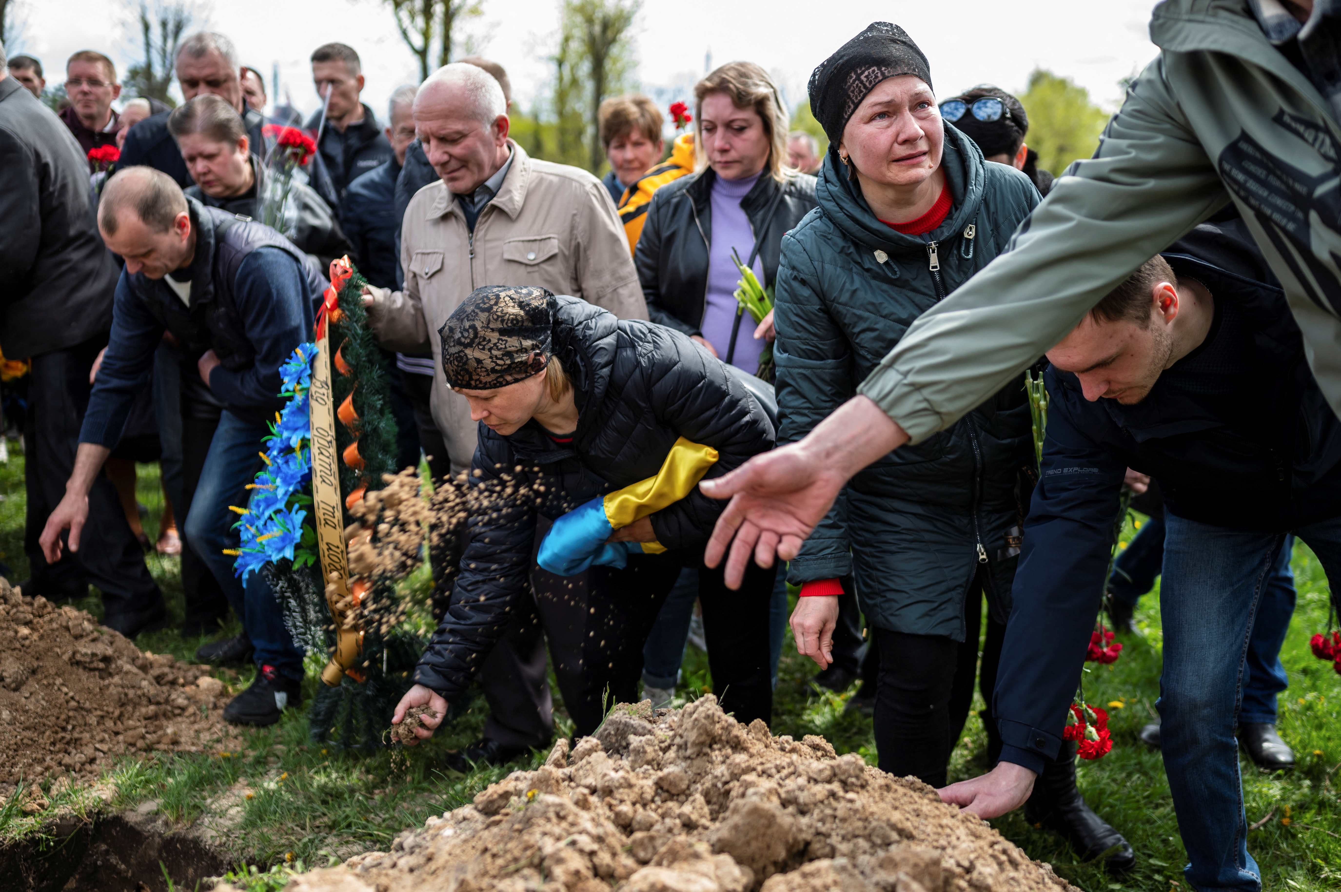 People attend the funeral of Ukrainian serviceman Andriy Butrik, 47, who was killed by a Russian shelling in Kurulka village in Kharkiv Region, amid Russia's invasion of Ukraine, in Zhytomyr, Ukraine