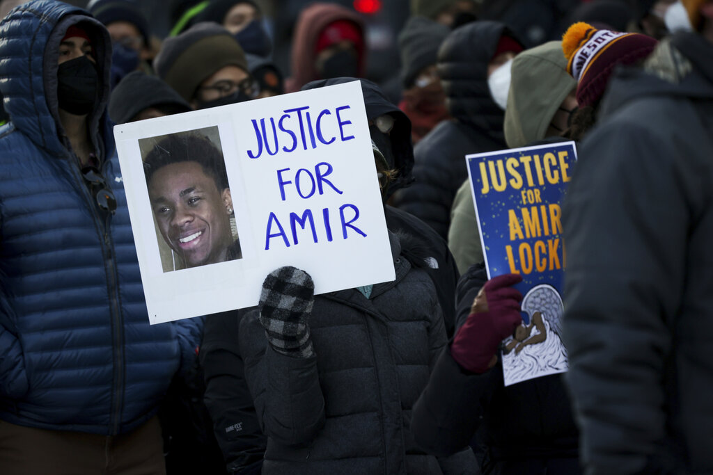 A protester holds a sign demanding justice for Amir Locke at a rally on February 5 in Minneapolis. A SWAT team shot and killed Locke, aged 22, while conducting a no-knock drug raid