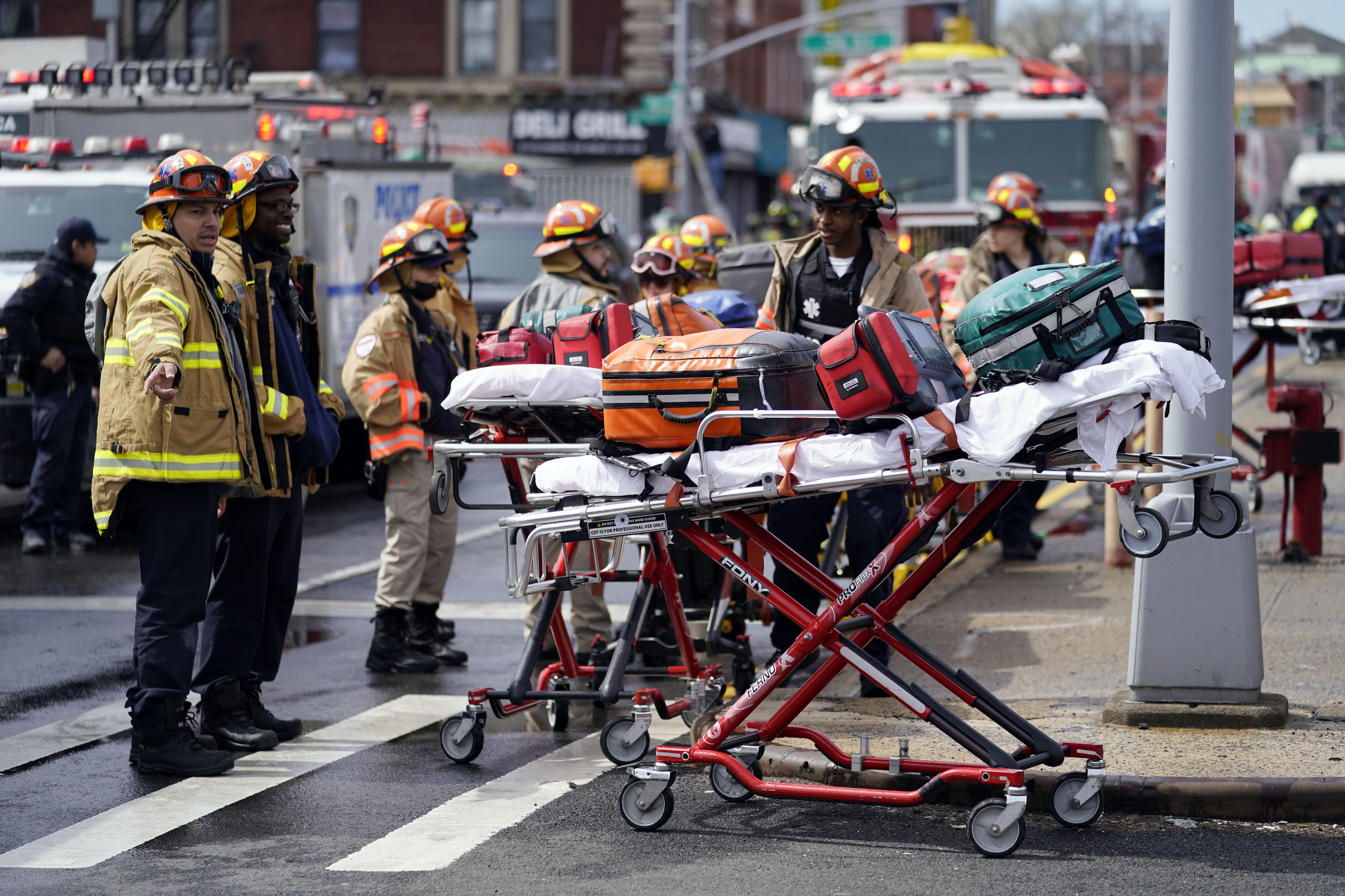Emergency personnel gather at the entrance to a subway stop in the Brooklyn borough of New York
