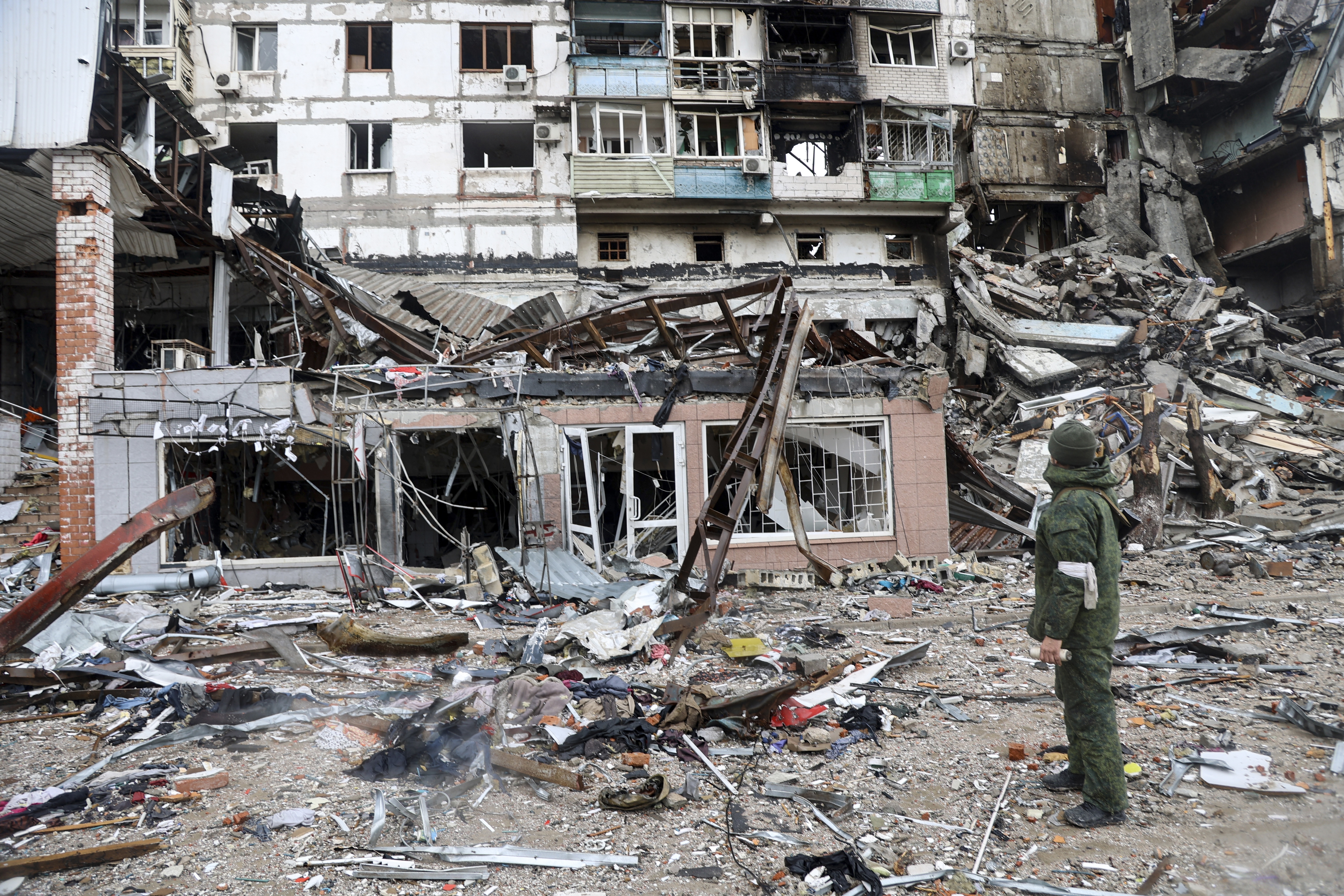 A serviceman stands at a building damaged during fighting in Mariupol, on the territory which is now under the Government of the Donetsk People’s Republic control, eastern in Mariupol, Ukraine