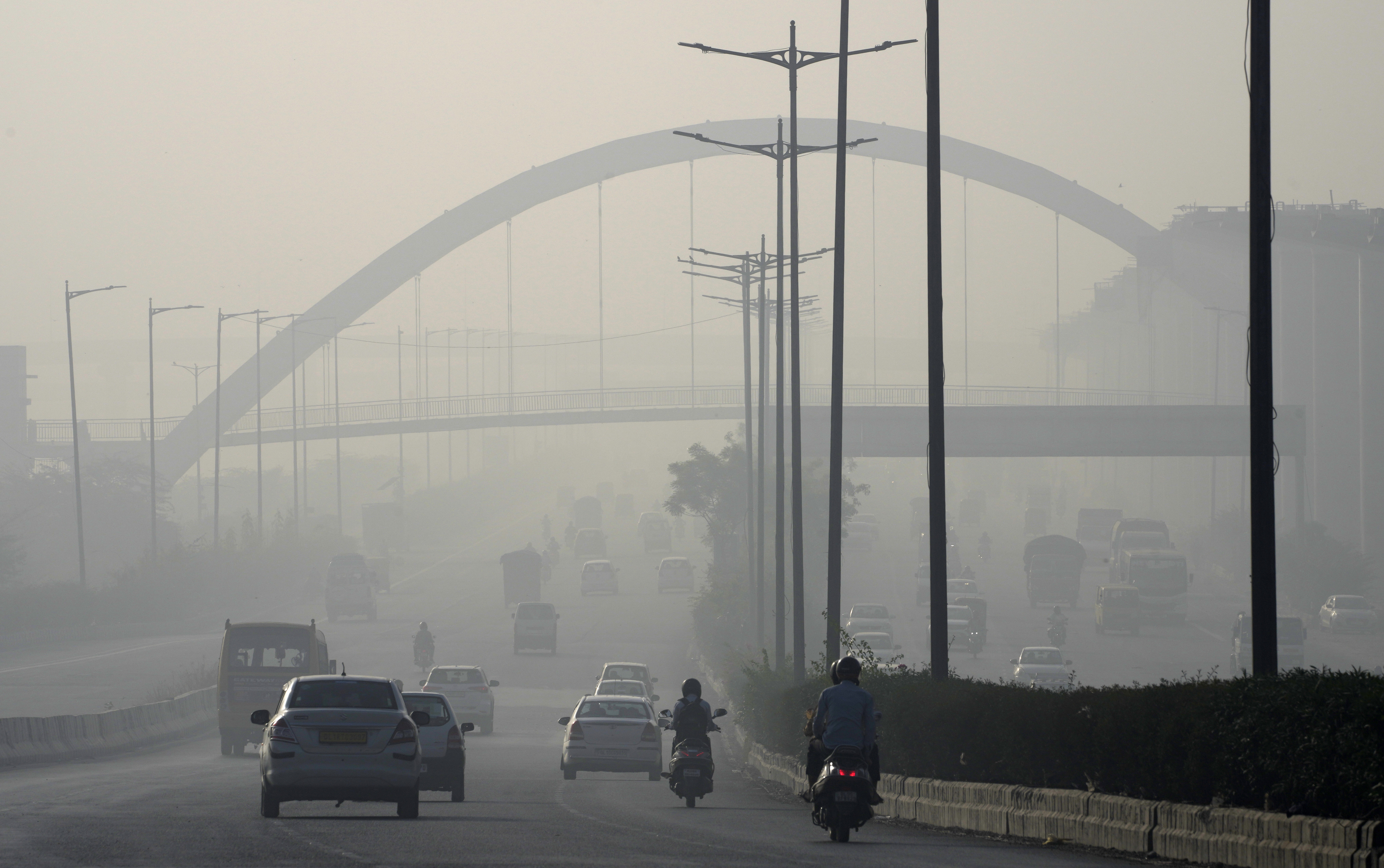 A thick layer of smoke coming out of a fire at the Bhalswa landfill envelopes New Delhi