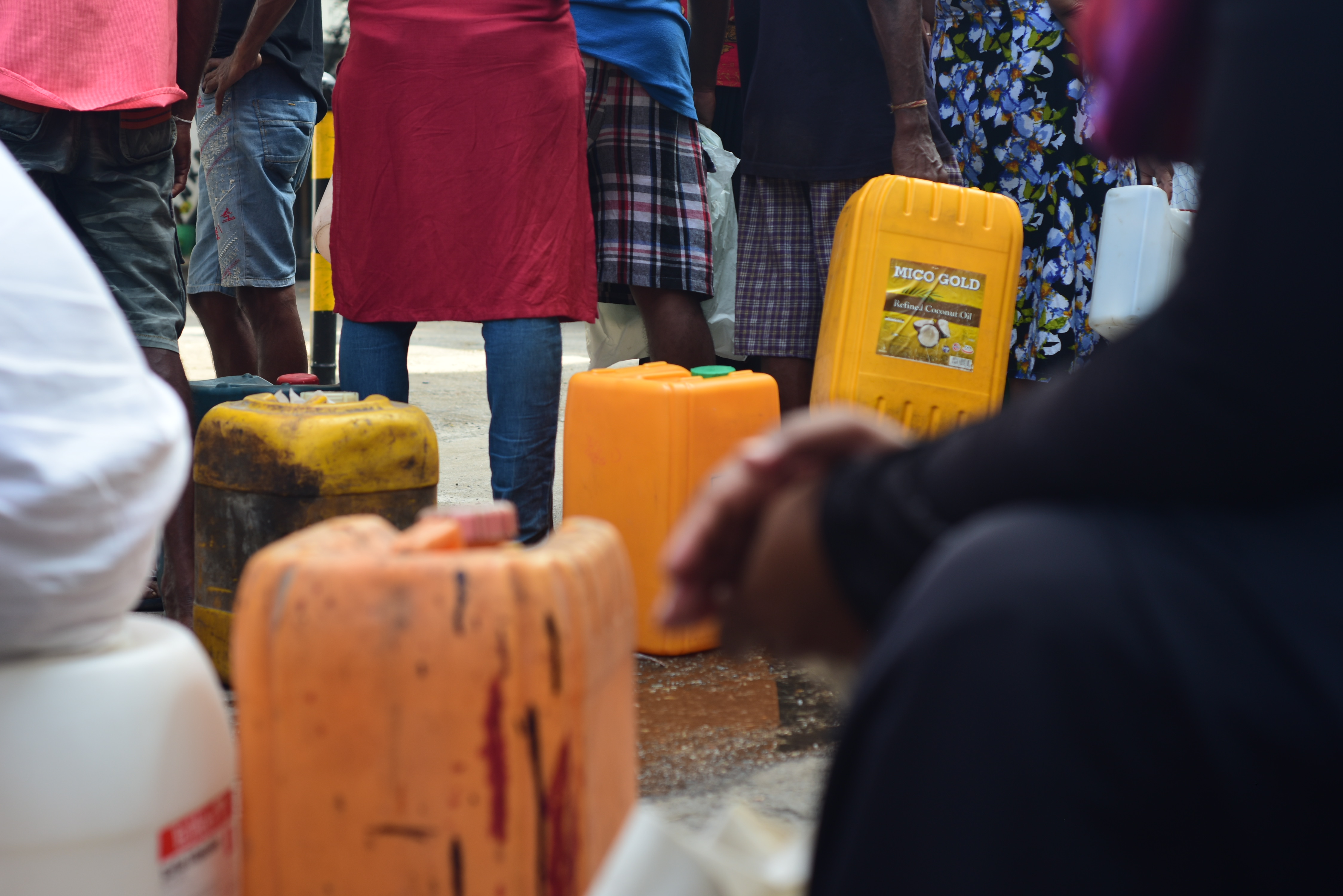 Canisters are seen at a petrol station as mainly poor Sri Lankans queue to buy kerosene