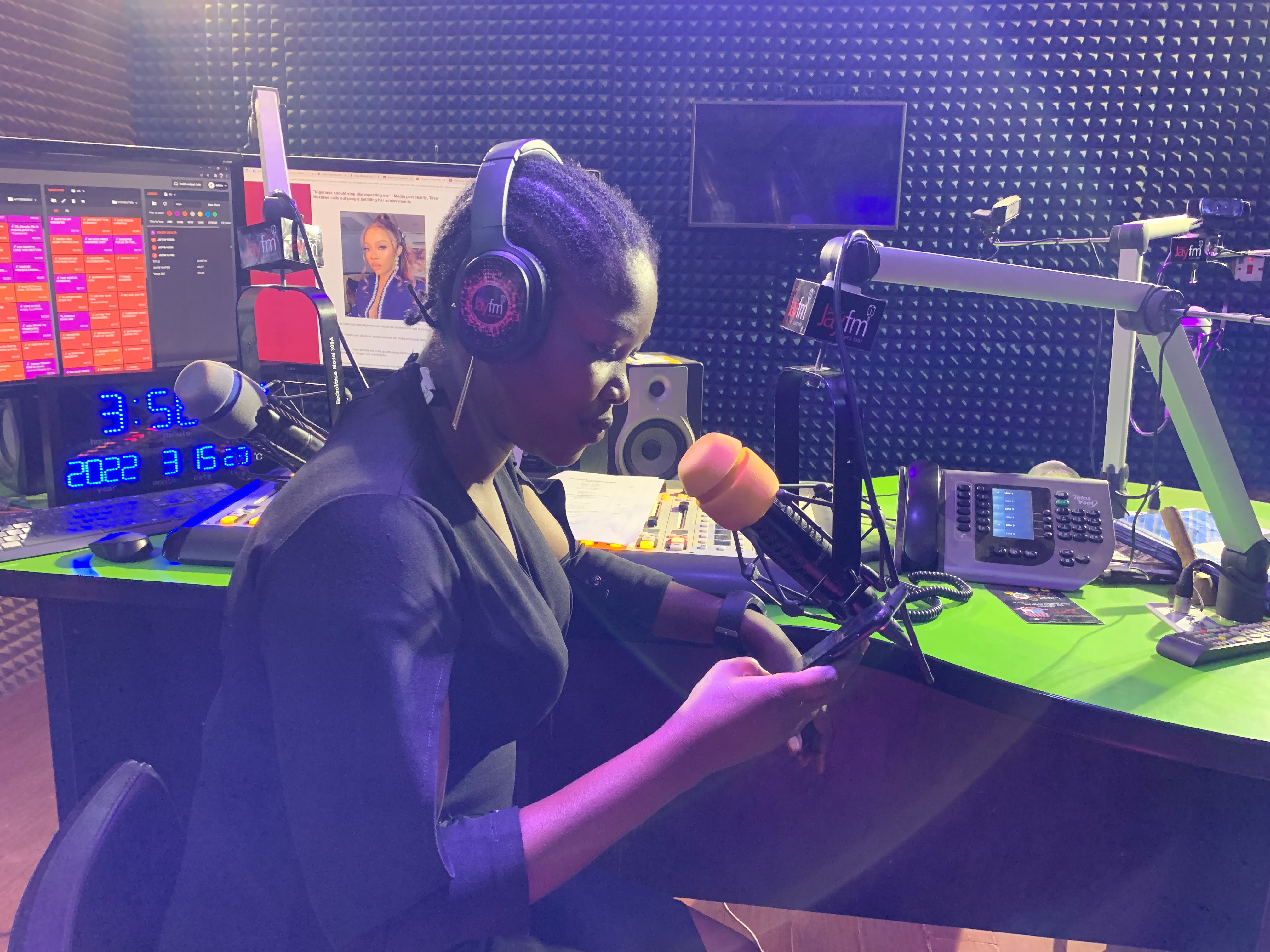 Nanji Nandang looks through listener comments and reactions on her phone