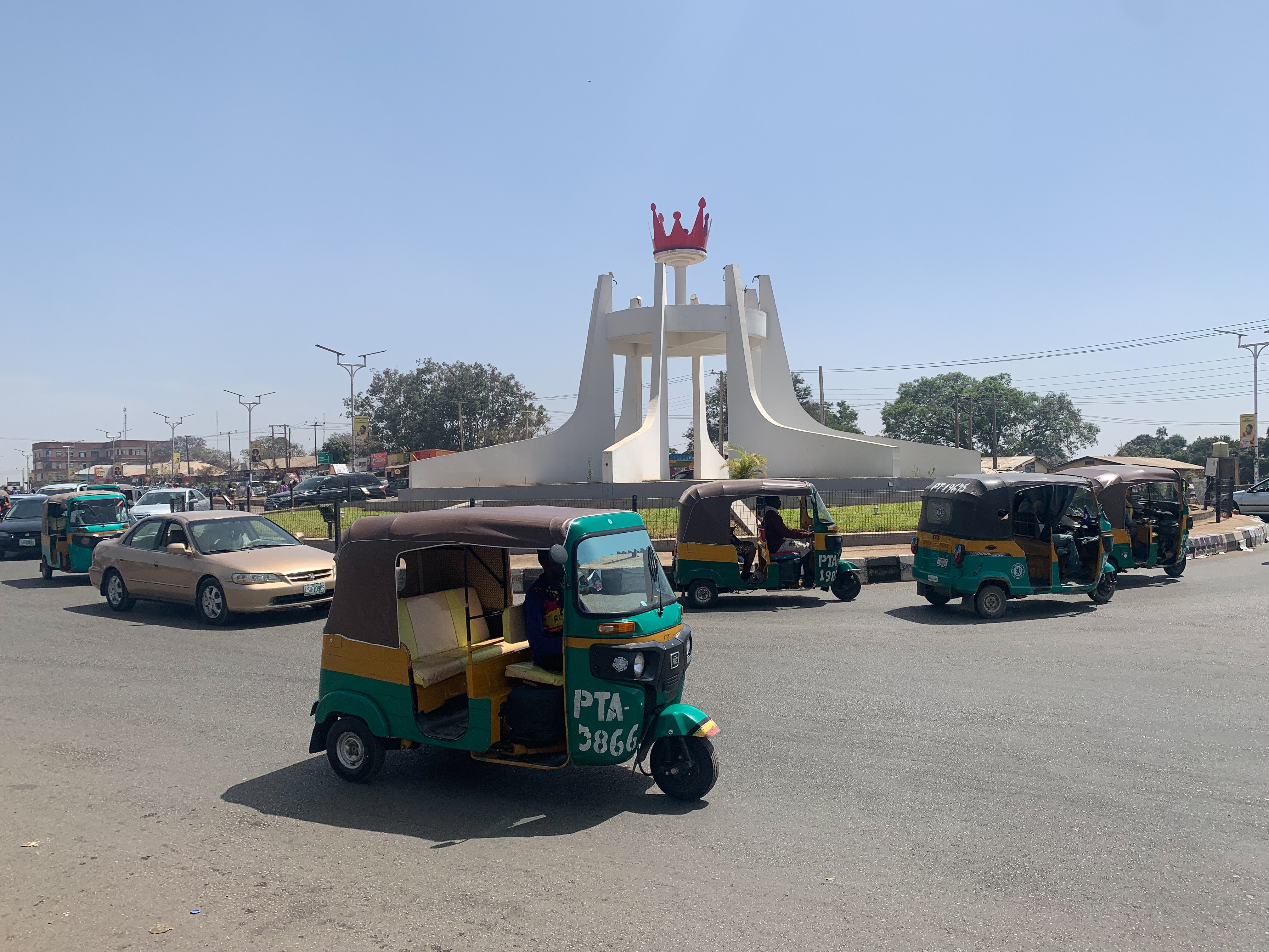 Tricycle taxis drive around a roundabout in Jos, Plateau state