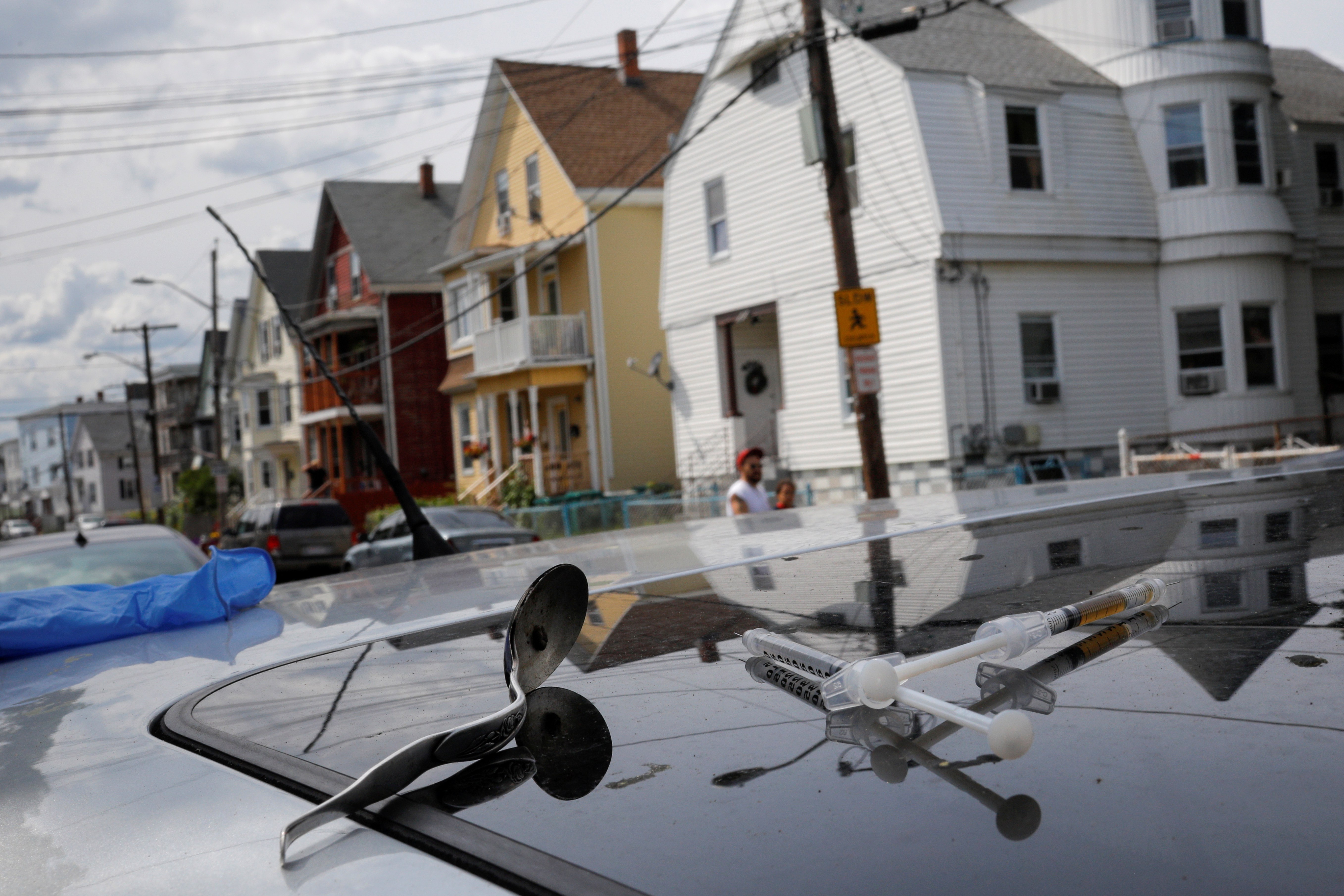 A full syringe, empty syringe and spoon sit on the roof of the car in which a man in his 20’s overdosed on an opioid in the Boston suburb of Lynn, Massachusetts in the US