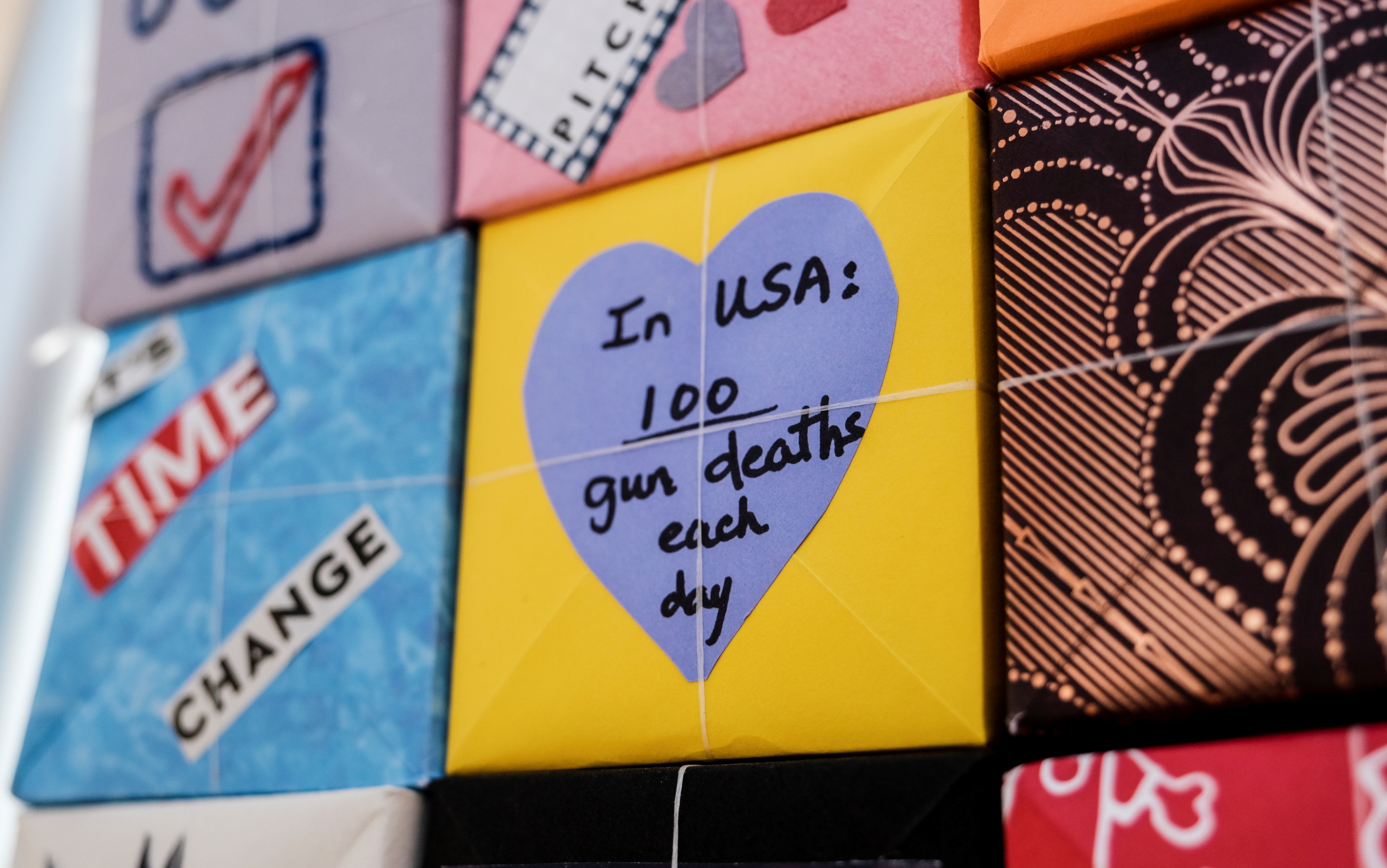 A box reads, In USA: 100 gun deaths each day
