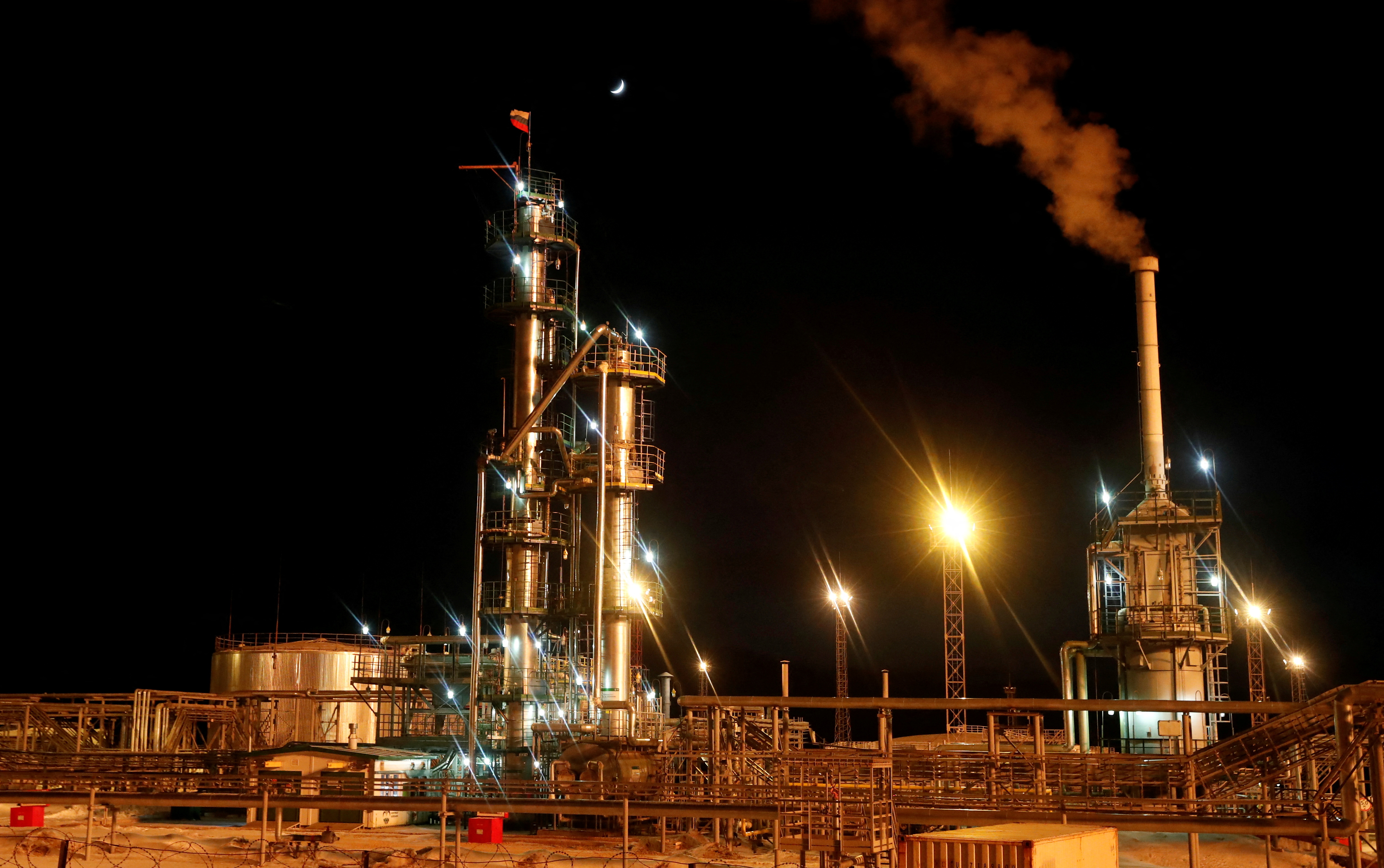 A Russian state flag flies on the top of a diesel plant