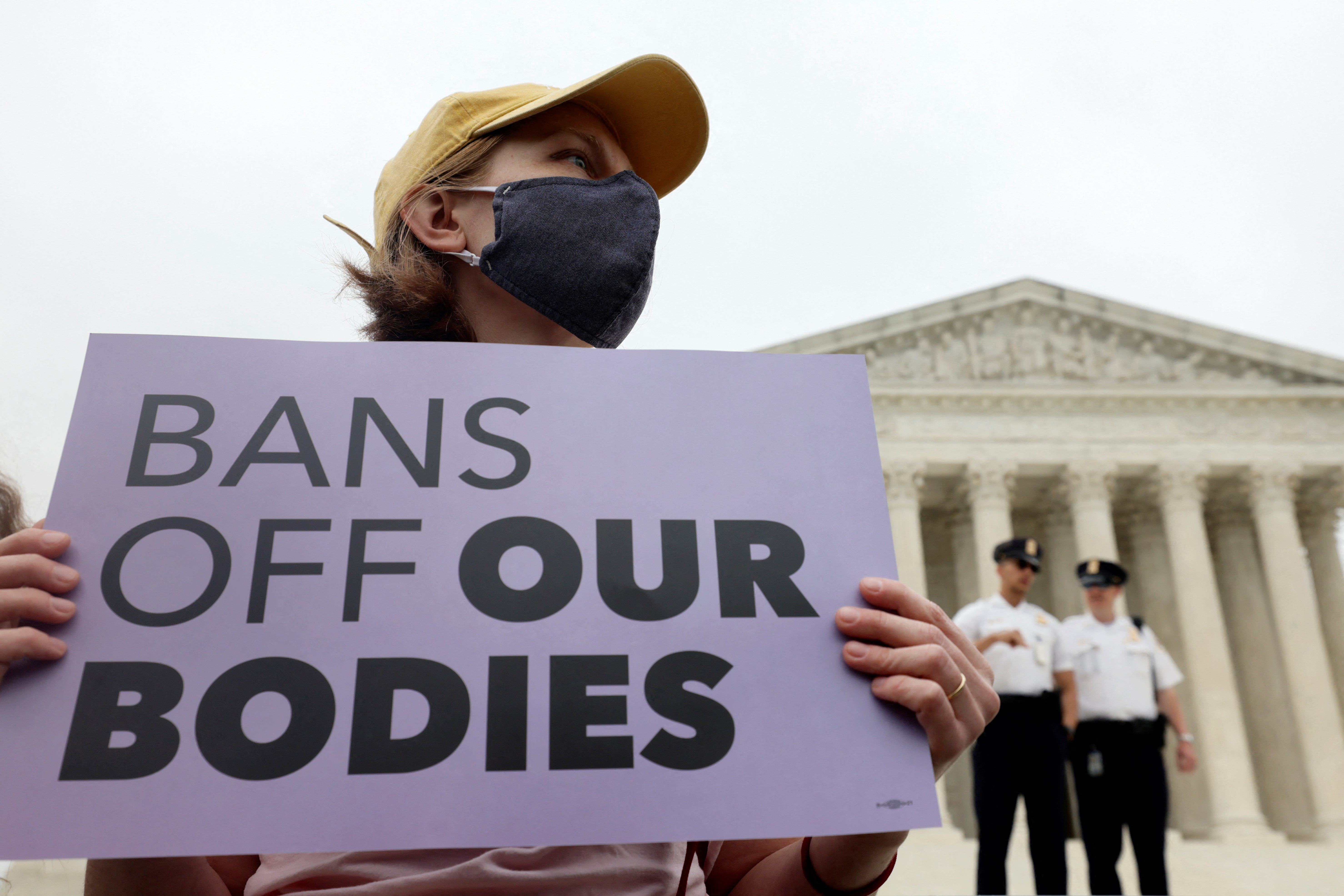 A demonstrator holds a sign during a protest outside the US Supreme Court, May 3