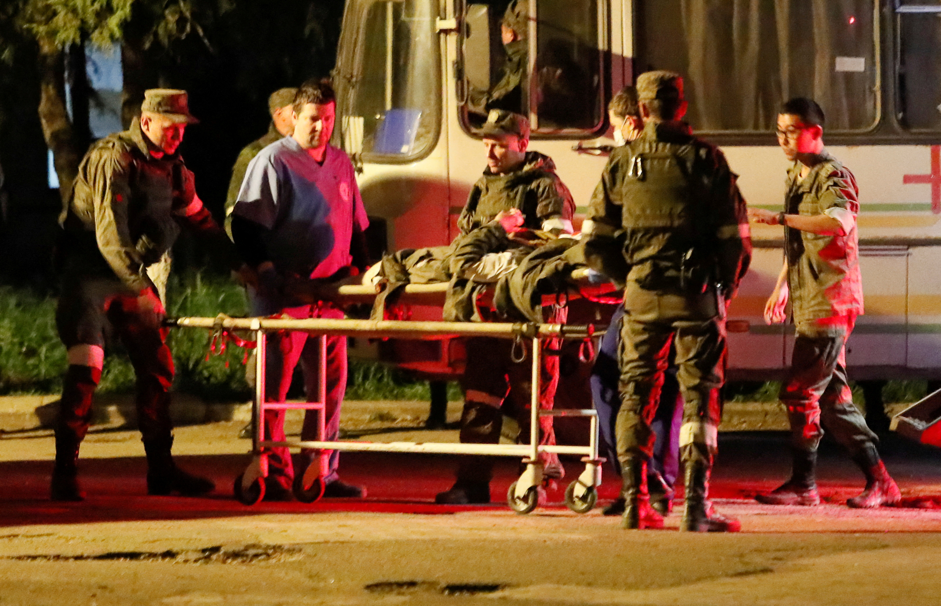 A wounded Ukrainian soldier from the Azovstal steel mill in Mariupol is transported out of a bus, which arrived under the escort of the pro-Russian military in Novoazovsk, May 16