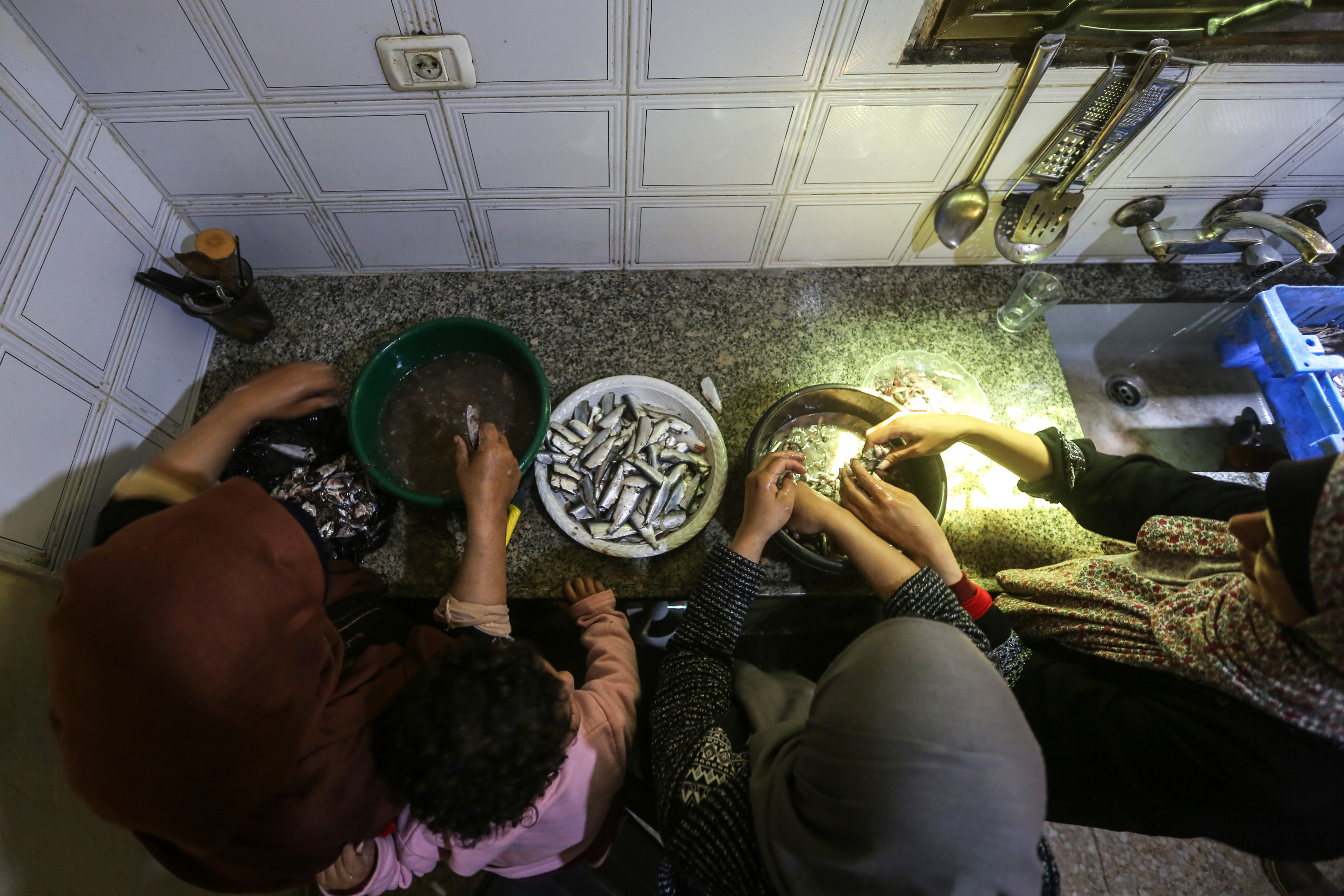 The women's busy hands - with very serious assistance from Sandy - make quick work of deboning the sardines and soon they’re ready for the next stage