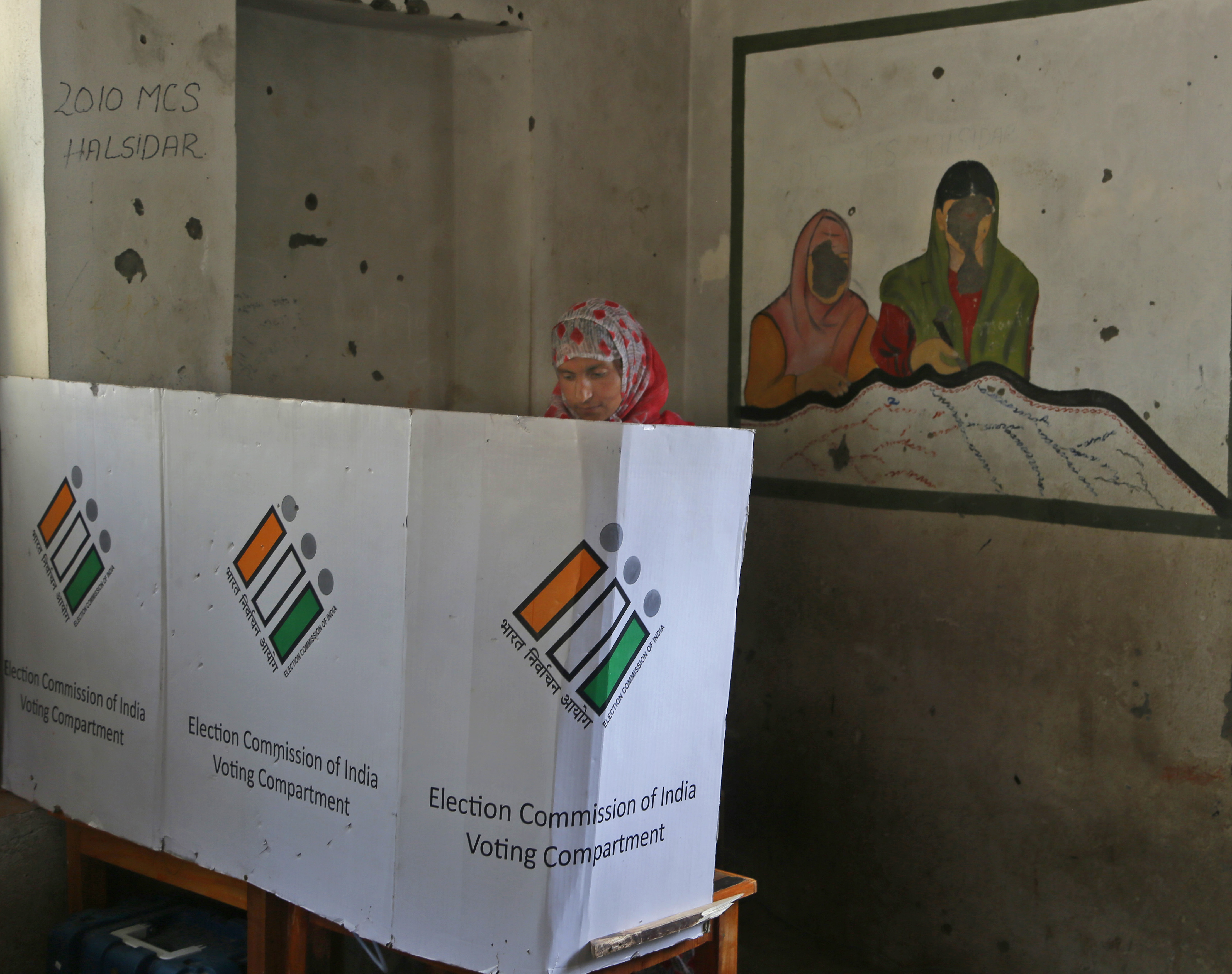A Kashmiri woman casts her vote at a polling station during India’s 2019 general elections, at Kapran, Indian -administered Kashmir