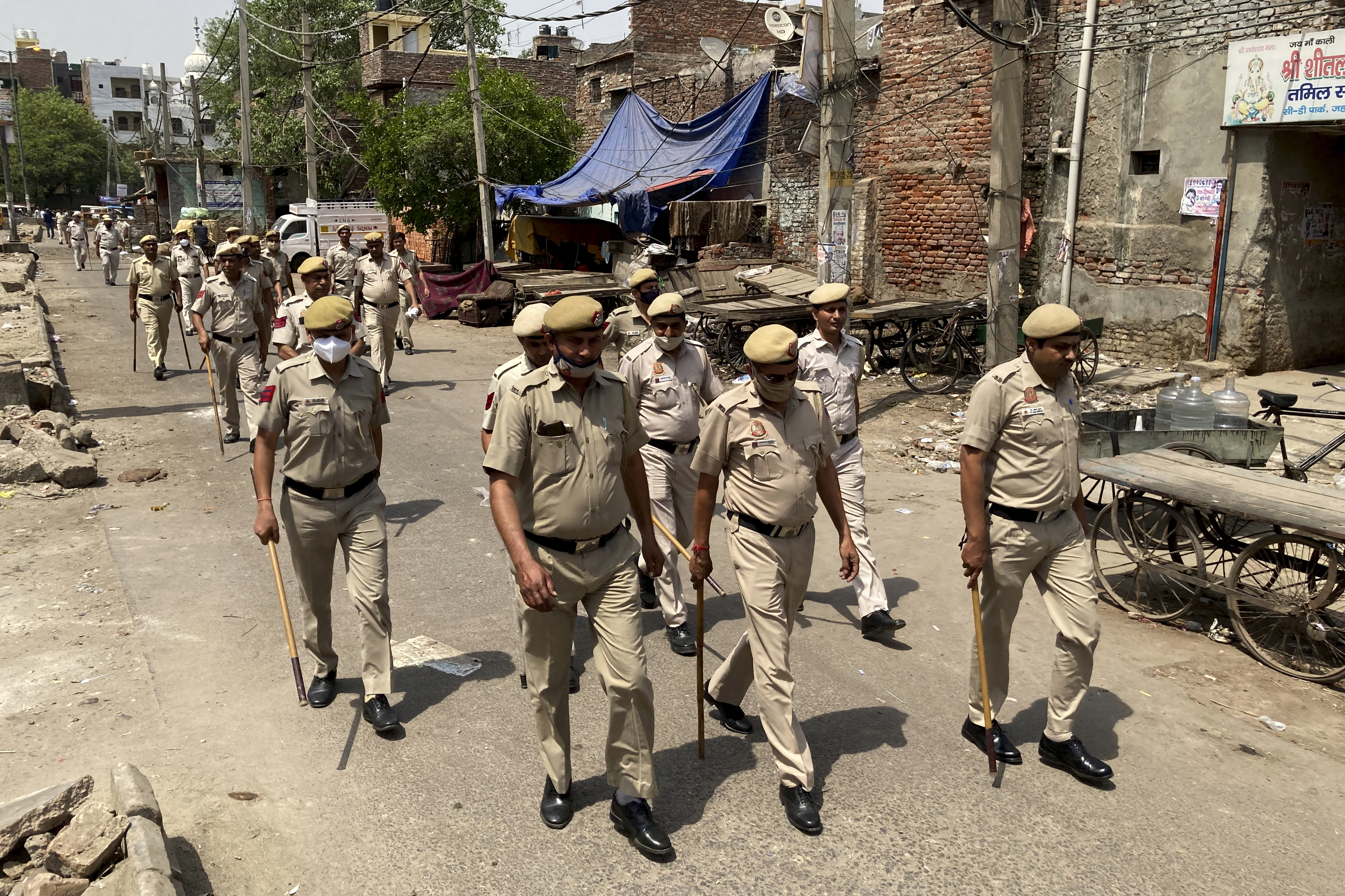 Policemen patrol a day after communal clashes in Jahangirpuri, a neighborhood in northwest Delhi,
