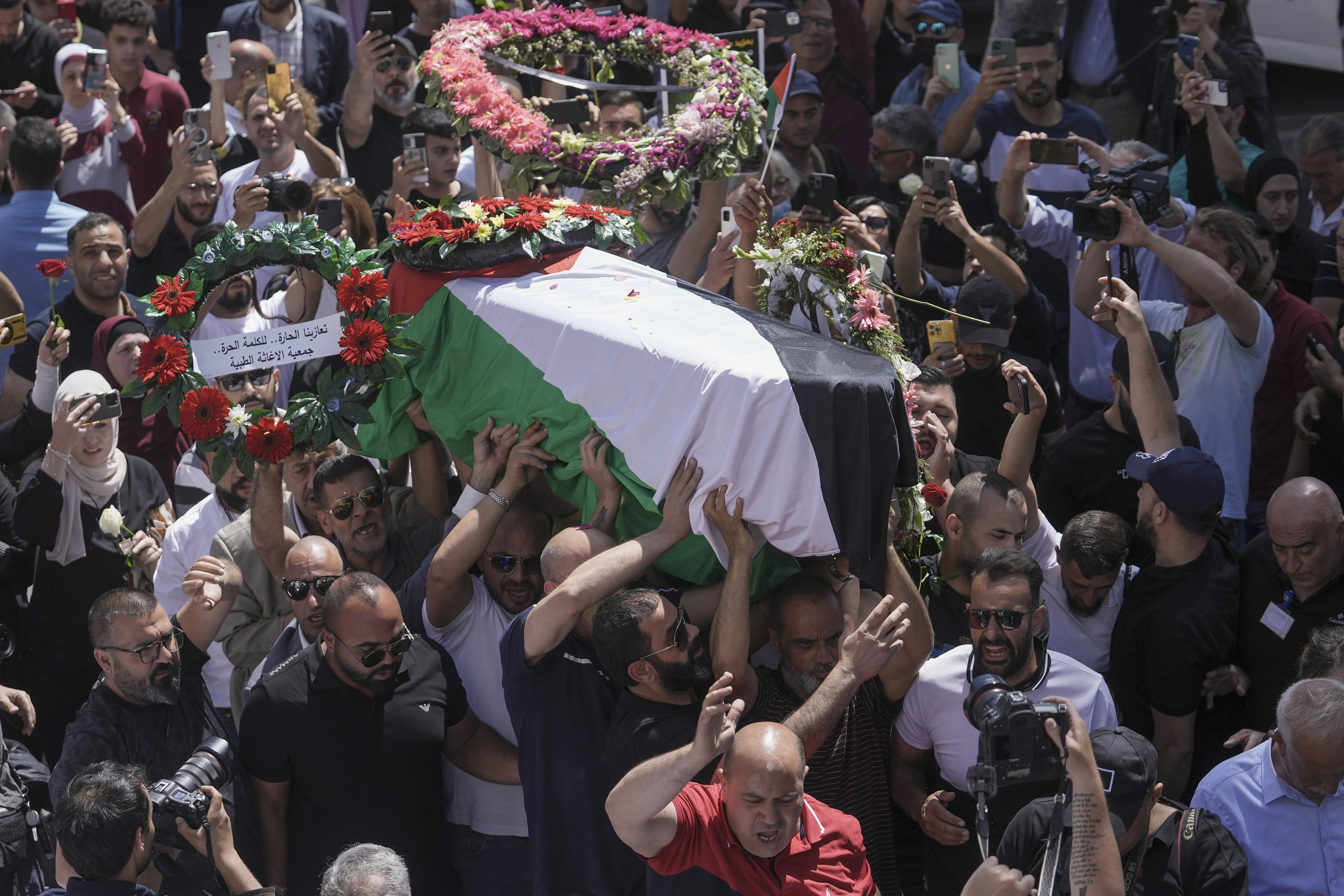 Family, friends and colleagues of slain Al Jazeera journalist Shireen Abu Akleh carry her coffin to a hospital in the occupied East Jerusalem neighbourhood of Sheikh Jarrah