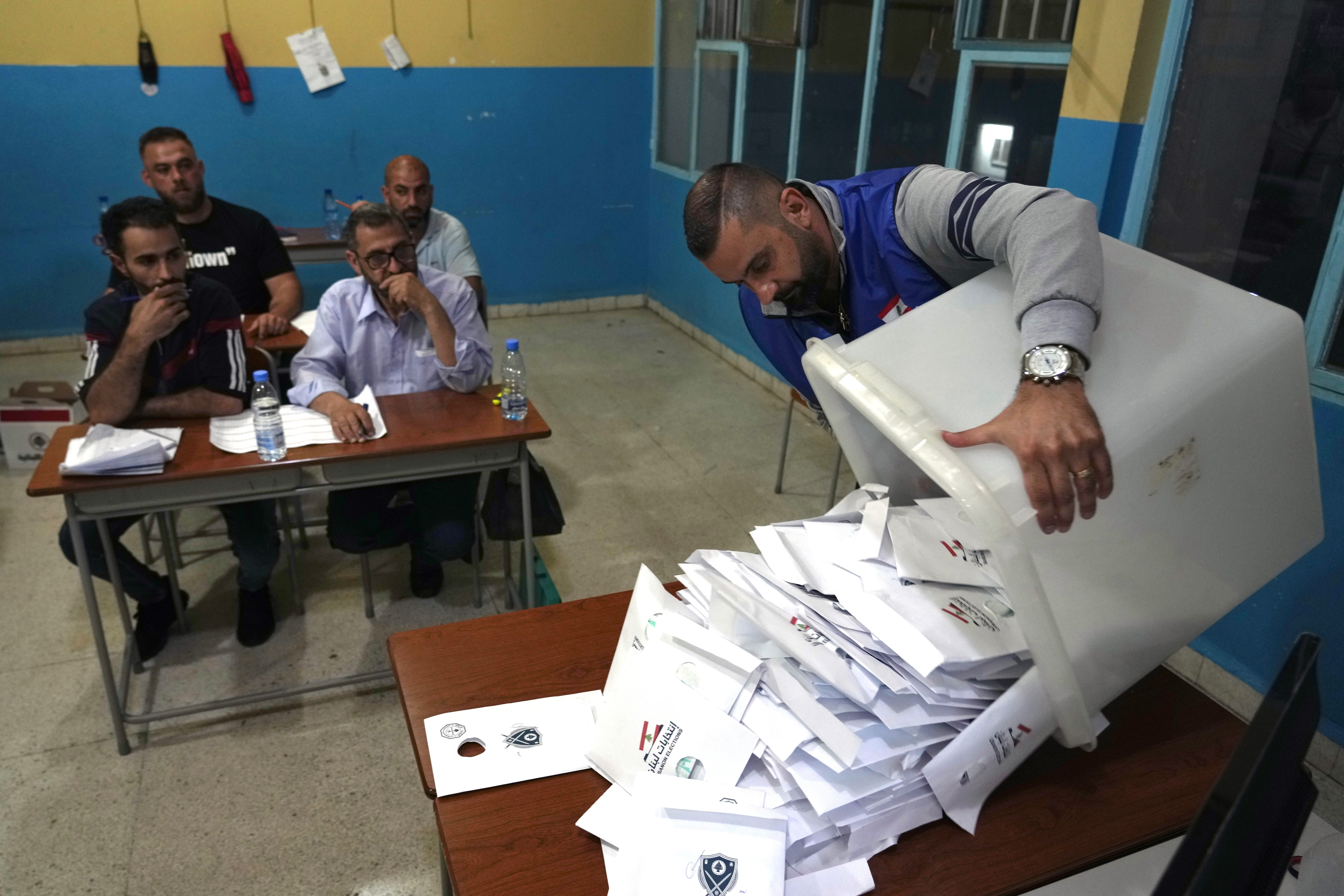 Election officials count ballots shortly after polling stations closed, in the northern city of Tripoli, Lebanon, Sunday, May 15, 2022. Lebanese voted for a new parliament Sunday against the backdrop of an economic meltdown that is transforming the country and low expectations that the election would significantly alter the political landscape.