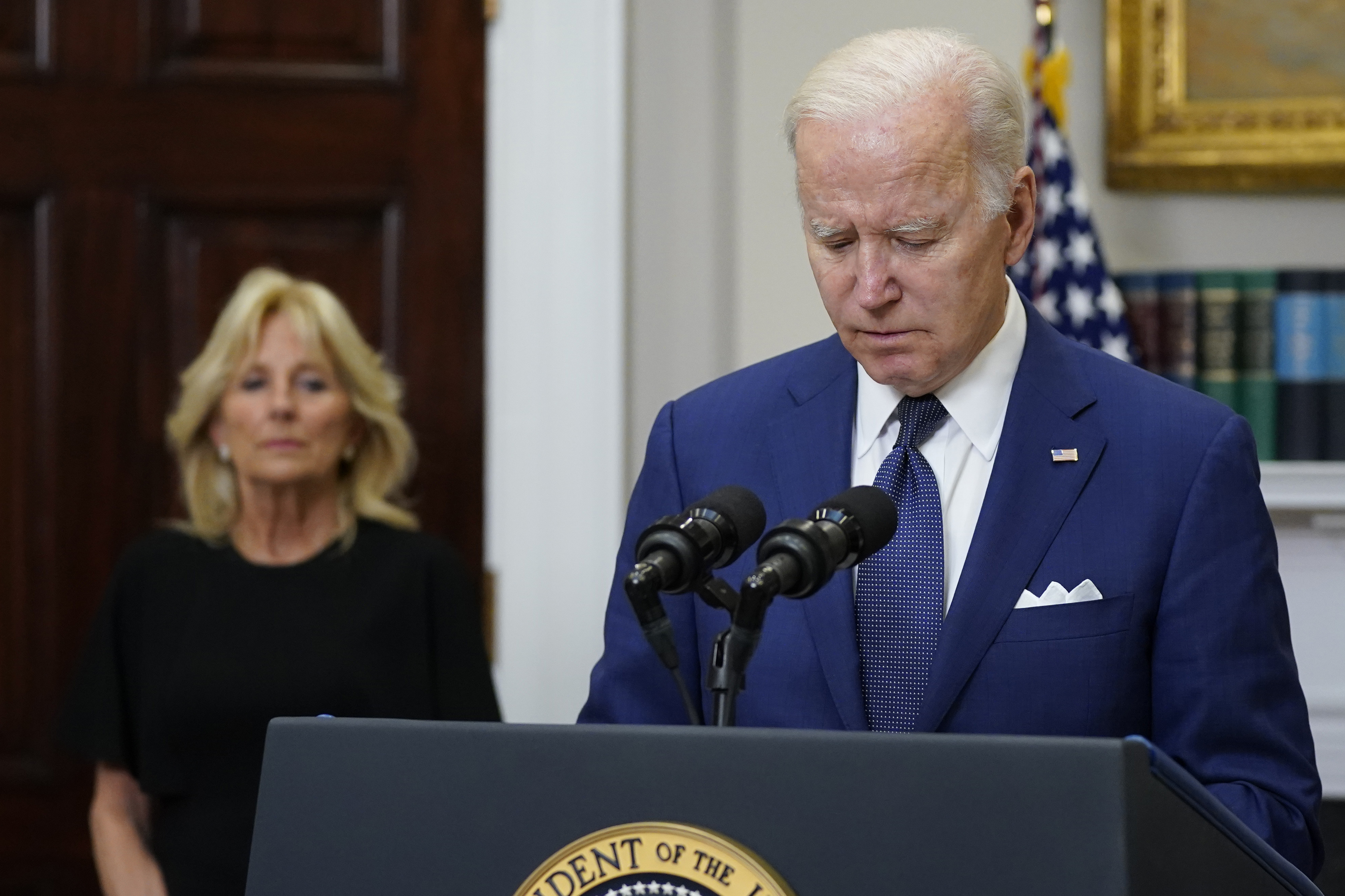 President Biden pauses as he speaks about the mass shooting at the Robb Elementary School from the White House as first lady Jill Biden listens