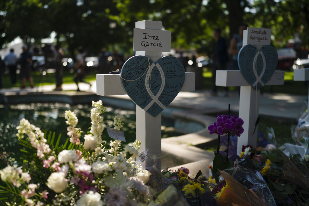 Messages are written on a cross honoring Irma Garcia, a teacher who was killed in this week's elementary school shooting, in Uvalde, Texas.