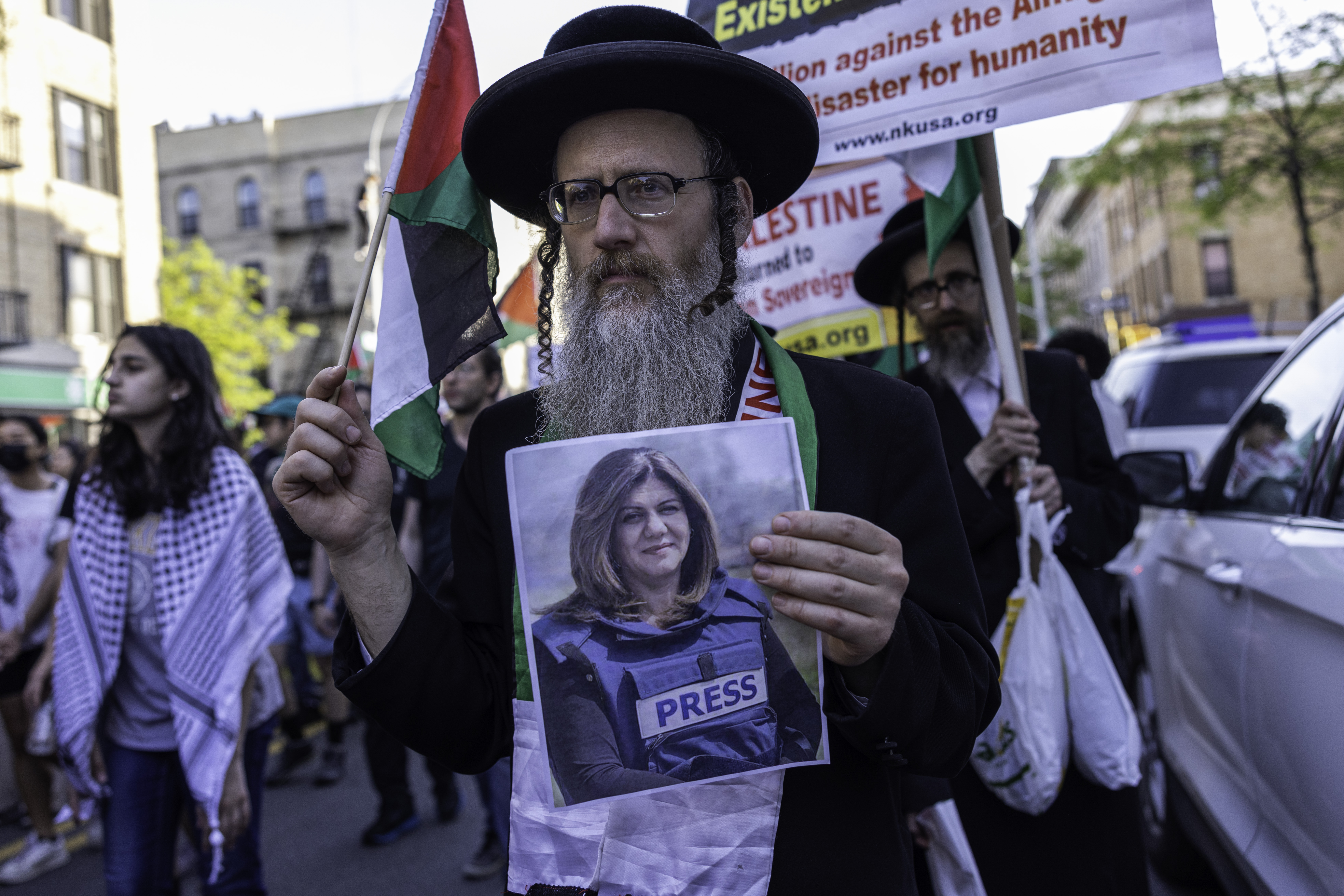 A Jewish man holds an image of Palestinian journalist Shireen Abu Akleh on May 15, 2022 in the Bay Ridge neighbourhood of the Brooklyn borough of New York City.