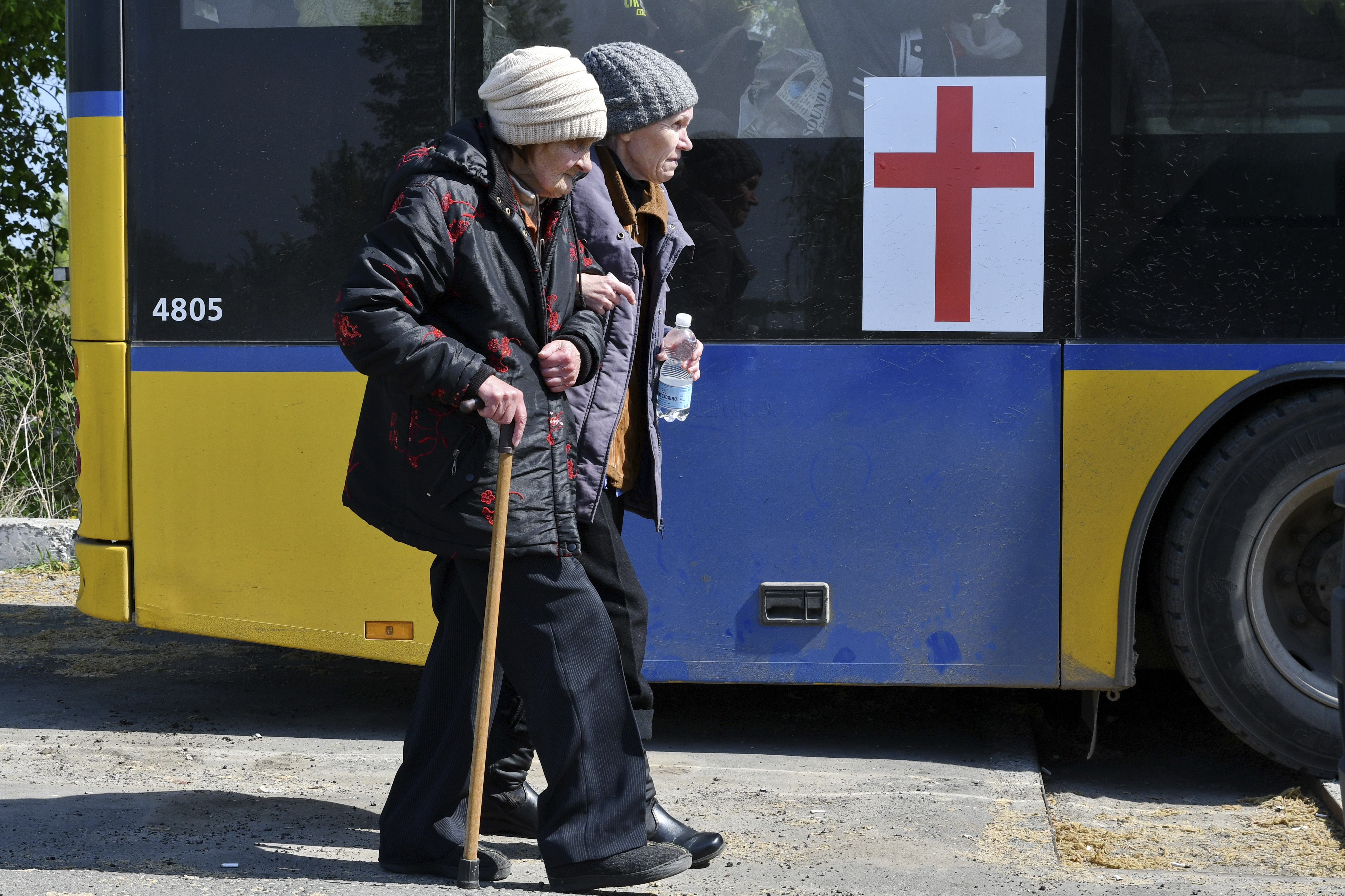 Women board a bus during an evacuation of civilians on a road near Slovyansk, eastern Ukraine, Wednesday, May 4, 2022