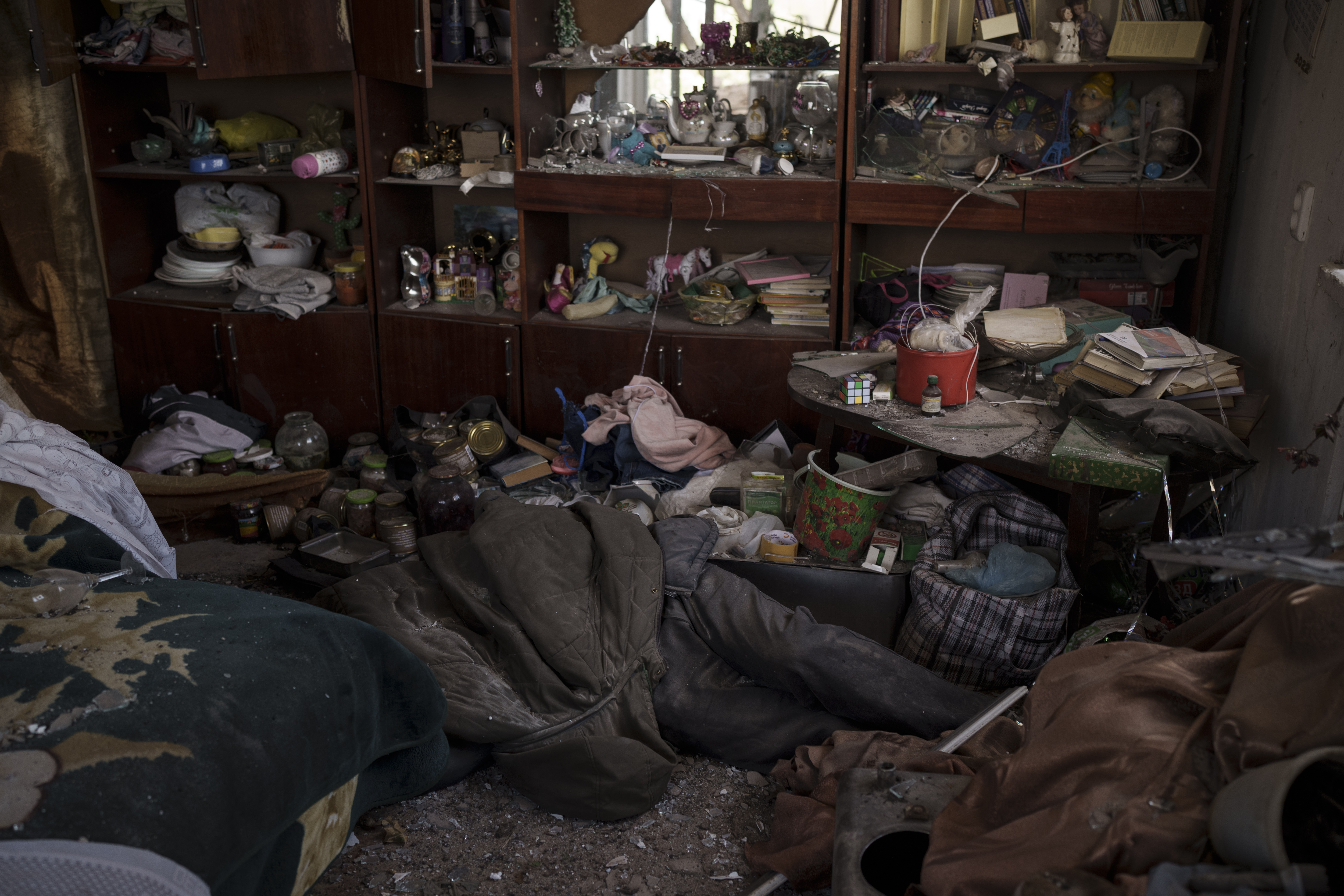The body of a civilian lies in an apartment as Russian bombardments continue in a village recently retaken by Ukrainian forces near Kharkiv