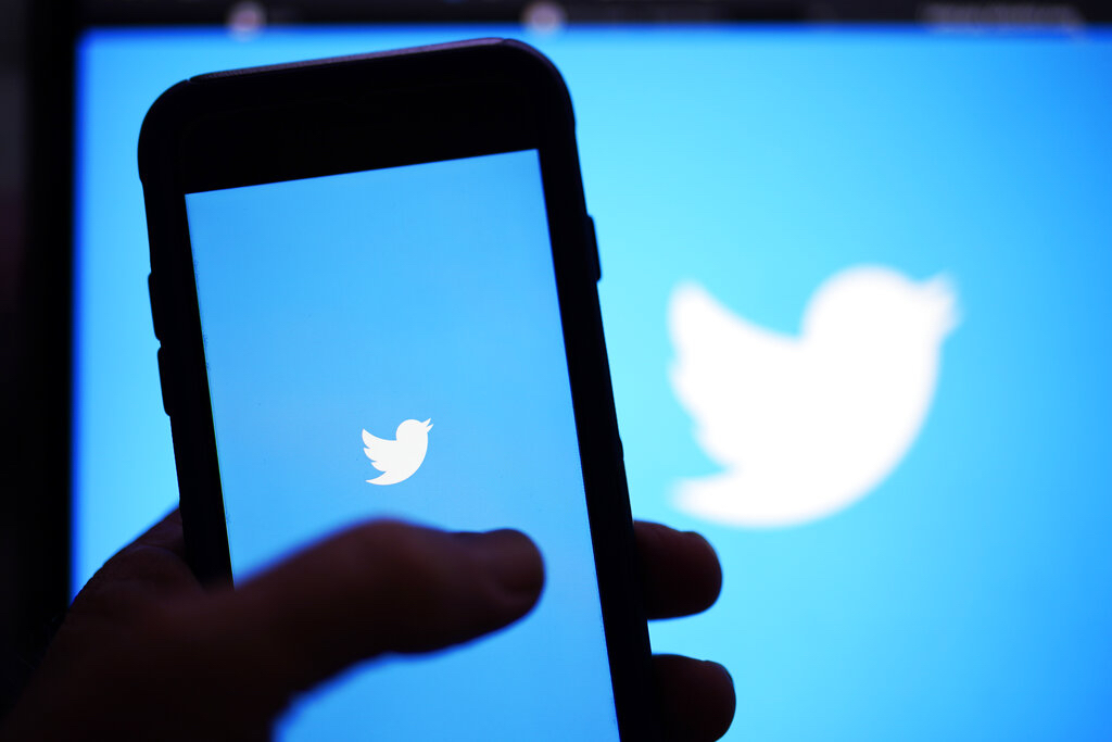 The Twitter application is seen on a digital device