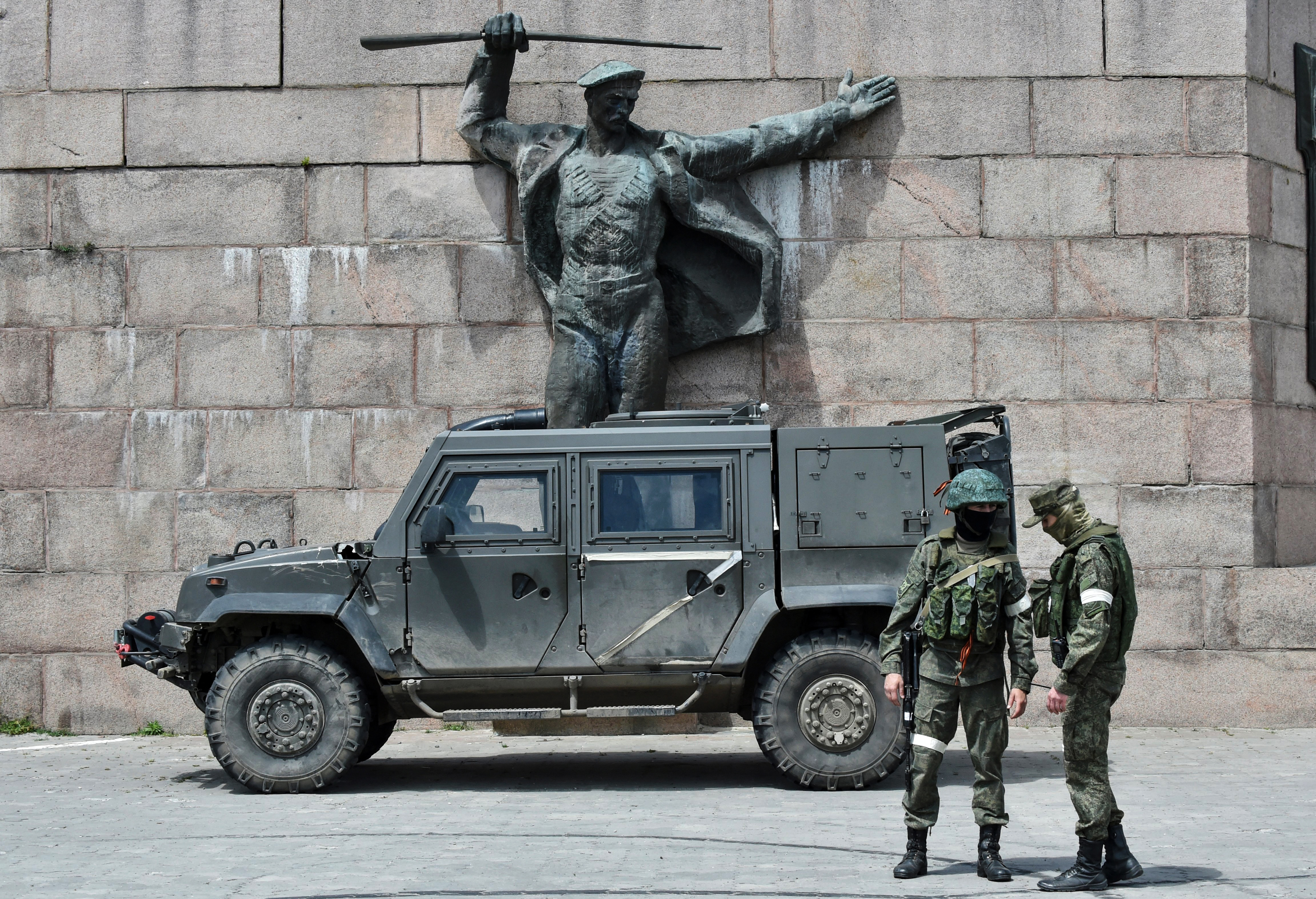 Russian service members patrolling at the Eternal Flame monument in Kherson, Ukraine.