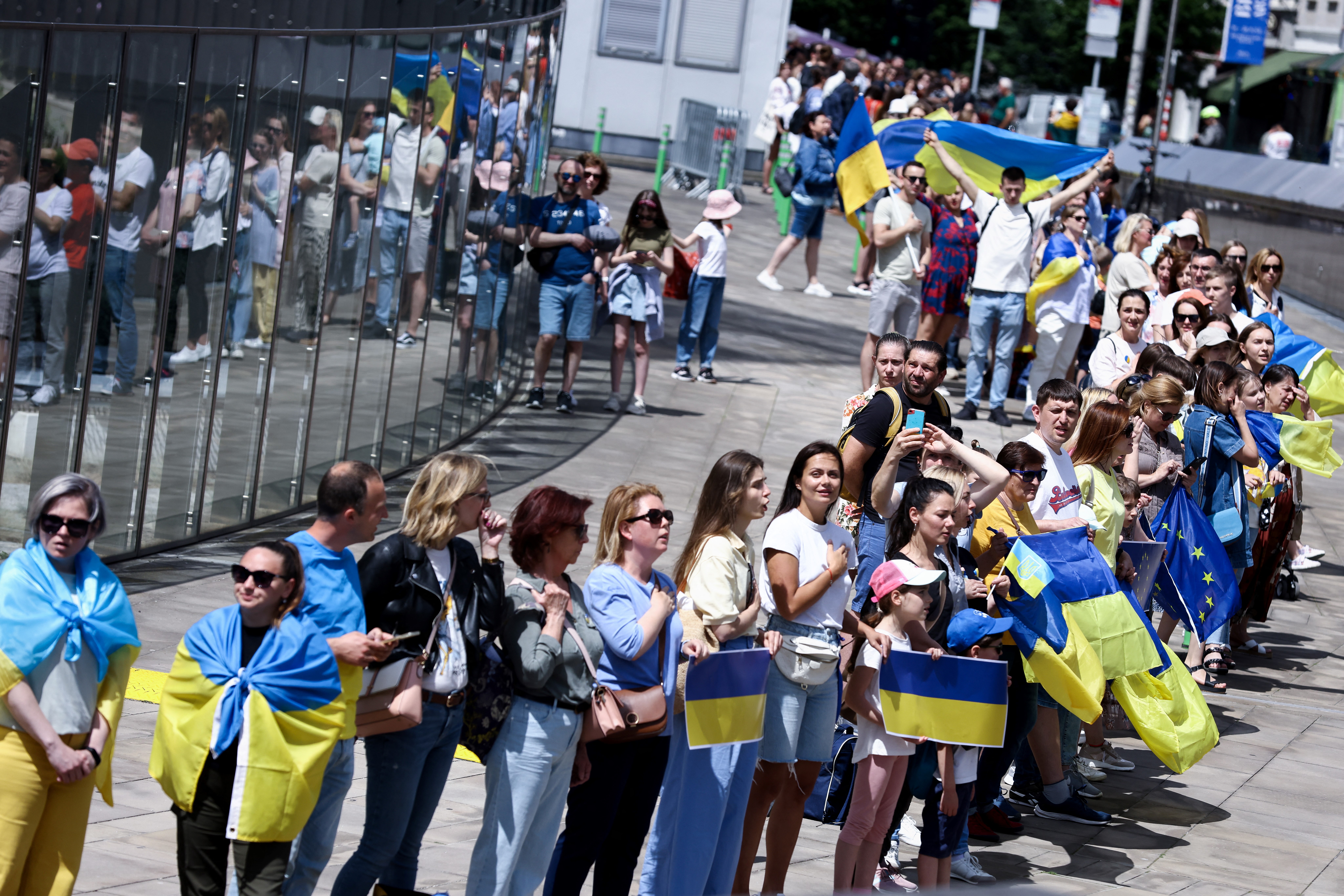 Demonstrators gather during a rally and take part in a human chain around the headquarters of the European Commission to support Ukraine’s application for EU candidacy status, in Brussels on June 12, 2022