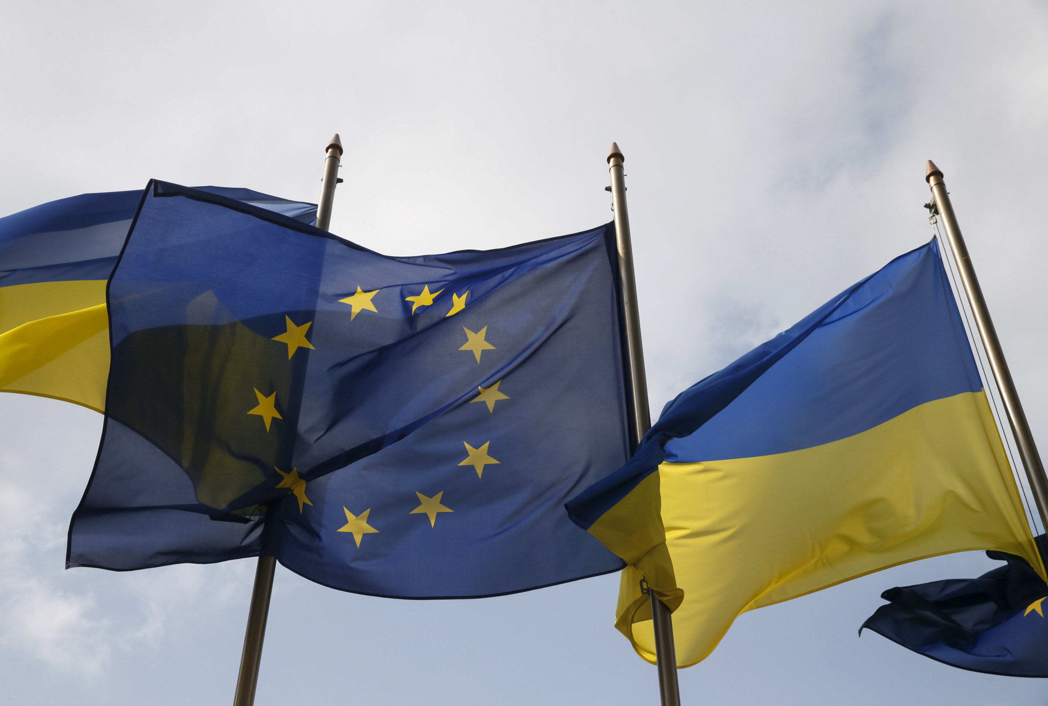 Ukrainian and EU flags fly in front of the Presidential Administration in Kiev, Ukraine