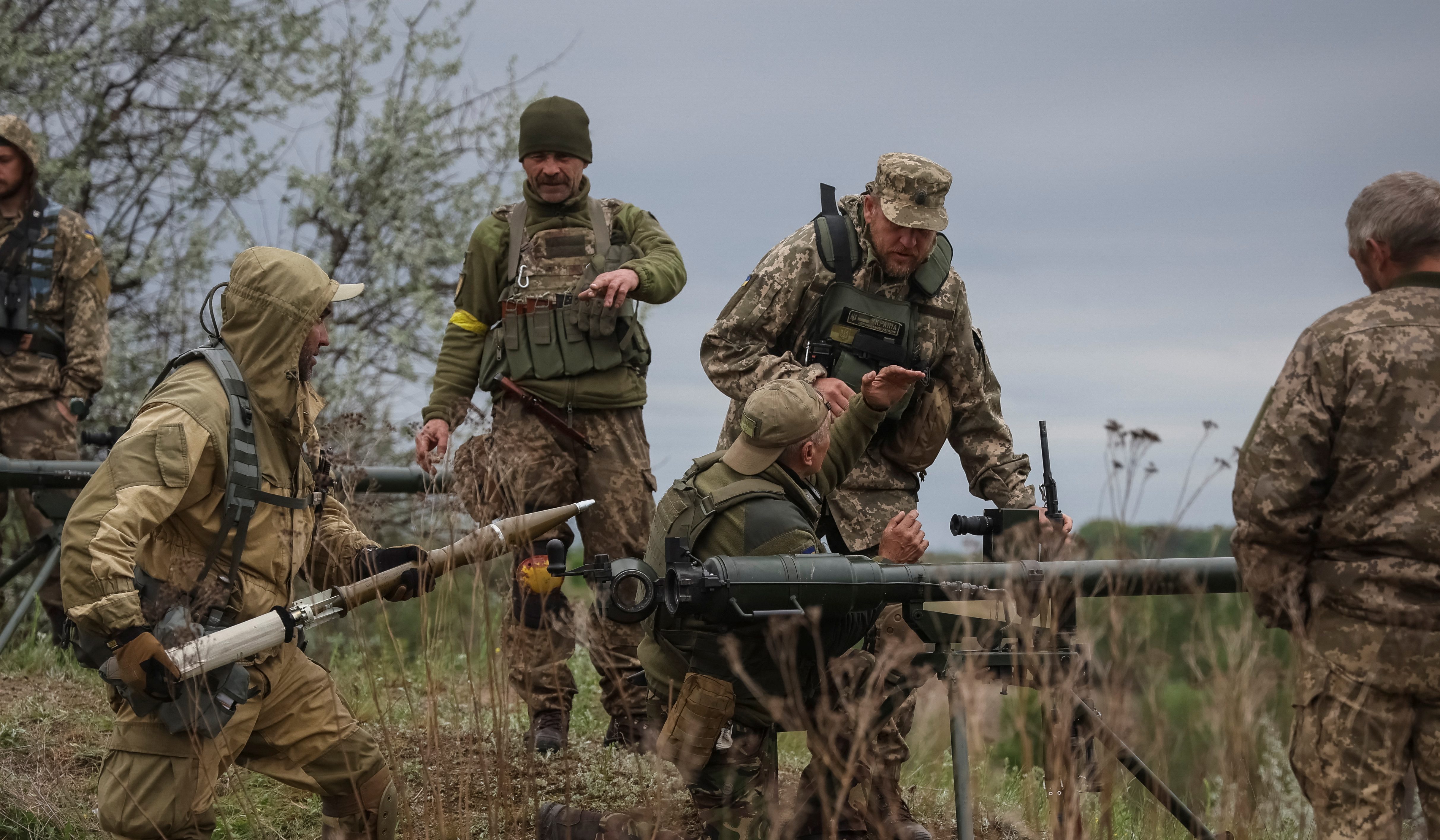 Ukrainian servicemen of the Territorial Defence Forces use an anti-tank grenade launcher