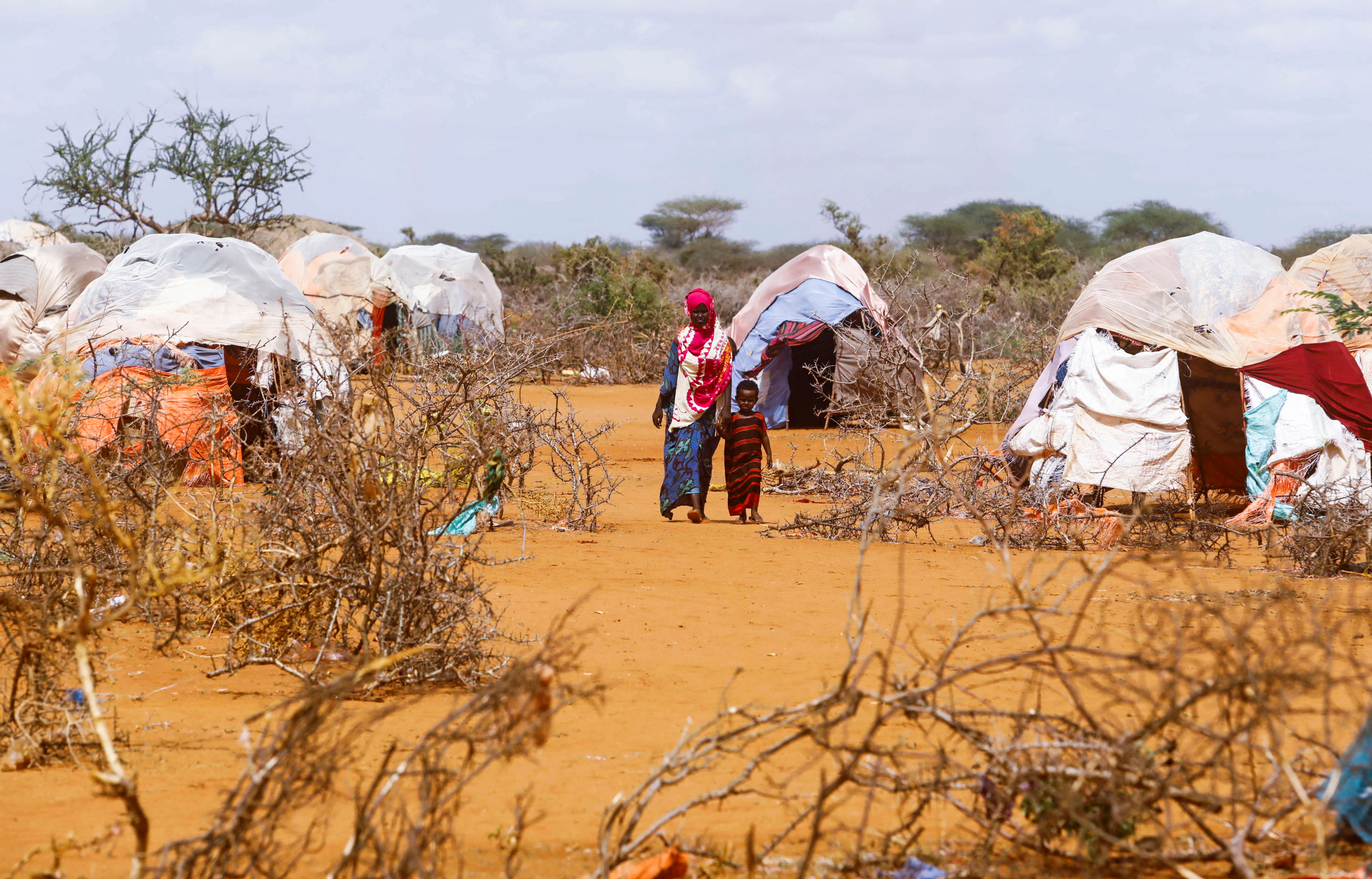 Civilians walk at the Kaxareey camp for the internally displaced people in Dollow, Gedo region of Somalia.