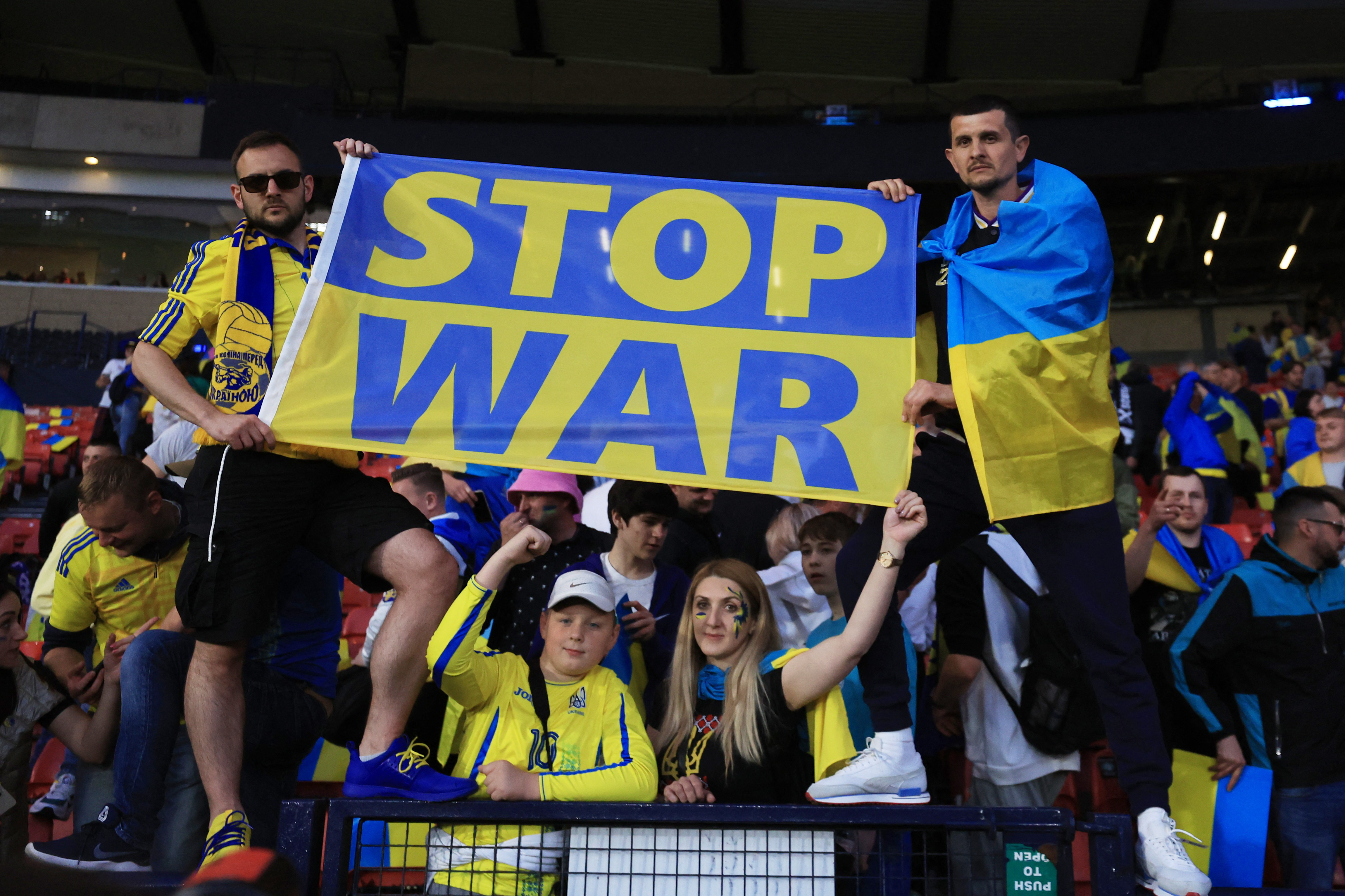 Ukraine football fans in blue and yellow celebrate Ukraine's World Cup victory over Scotland