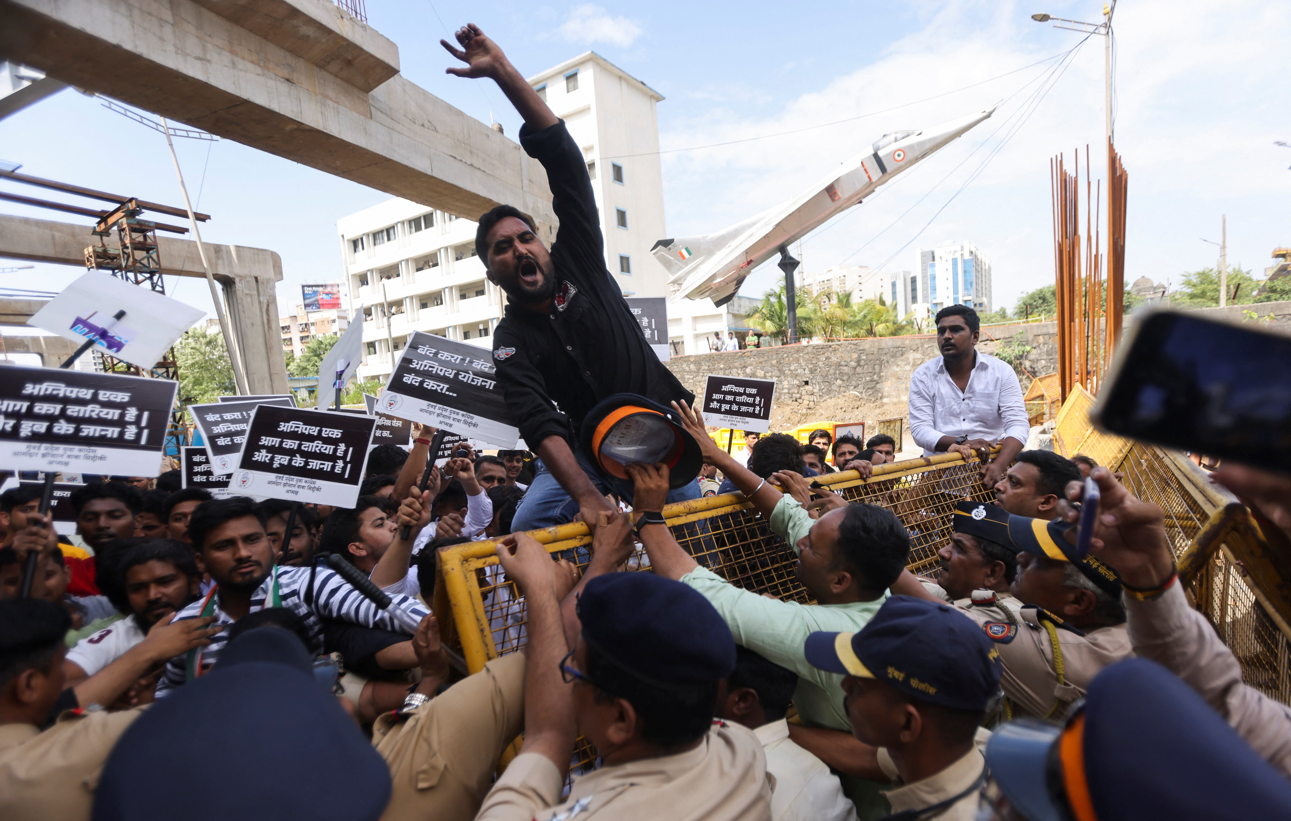 Police stop protesters as they attempt to cross a barricade in Mumbai