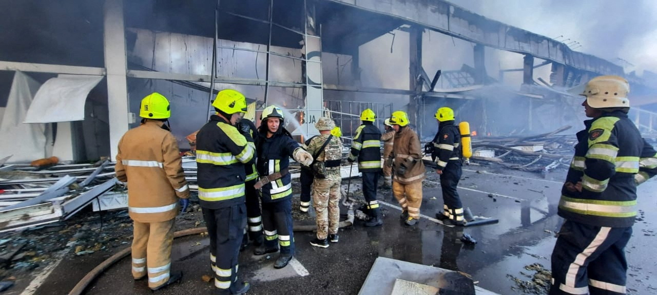 Rescuers work at the site of a shopping mall hit by a Russian missile strike in Kremenchuk, Ukraine [Press service of the State Emergency Service of Ukraine via Reuters]