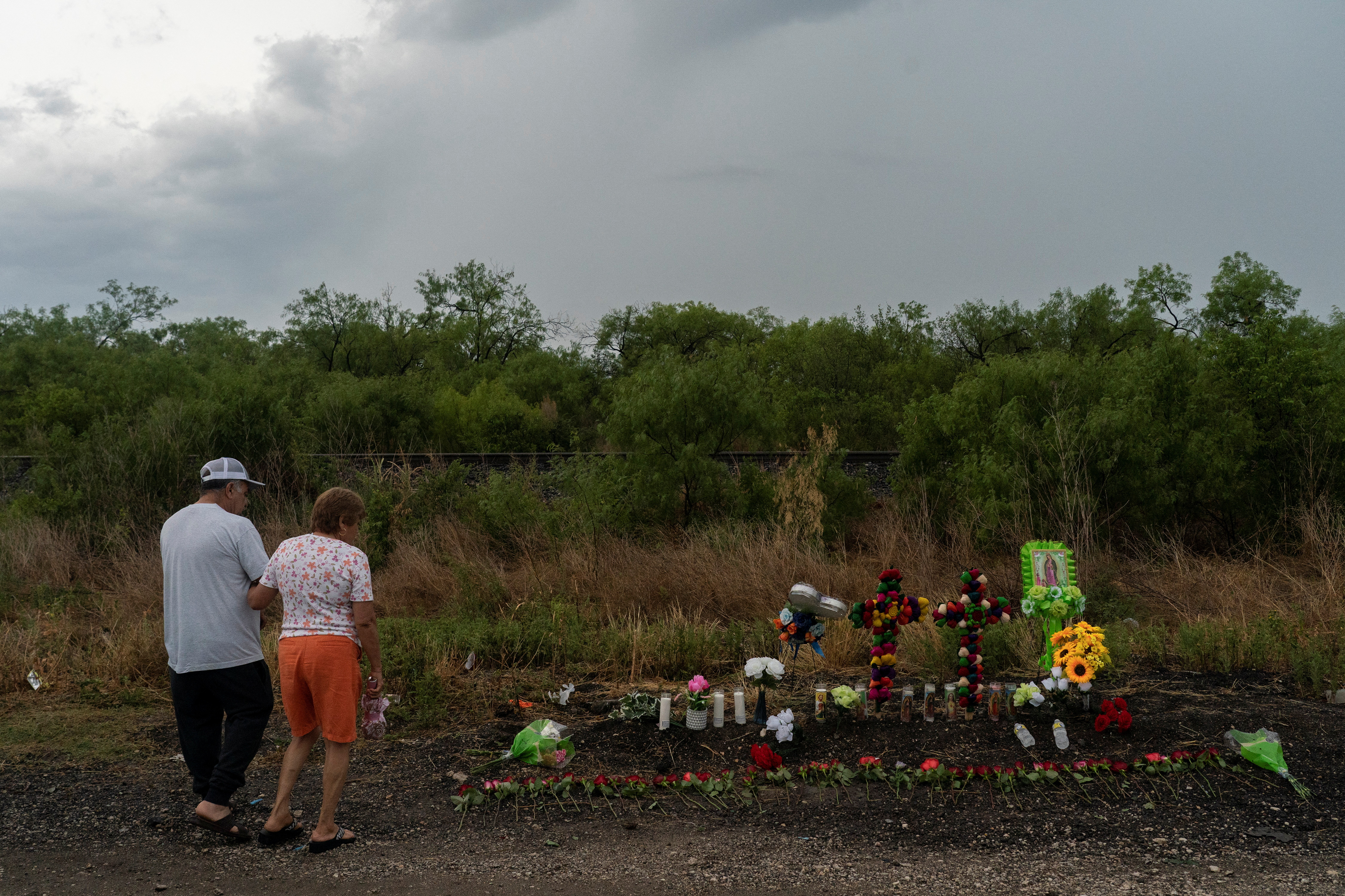 Residents pay a visit to mourn the victims at the scene where dozens of refugees and migrants were found dead inside a trailer truck in San Antonio, Texas, US, on June 28, 2022