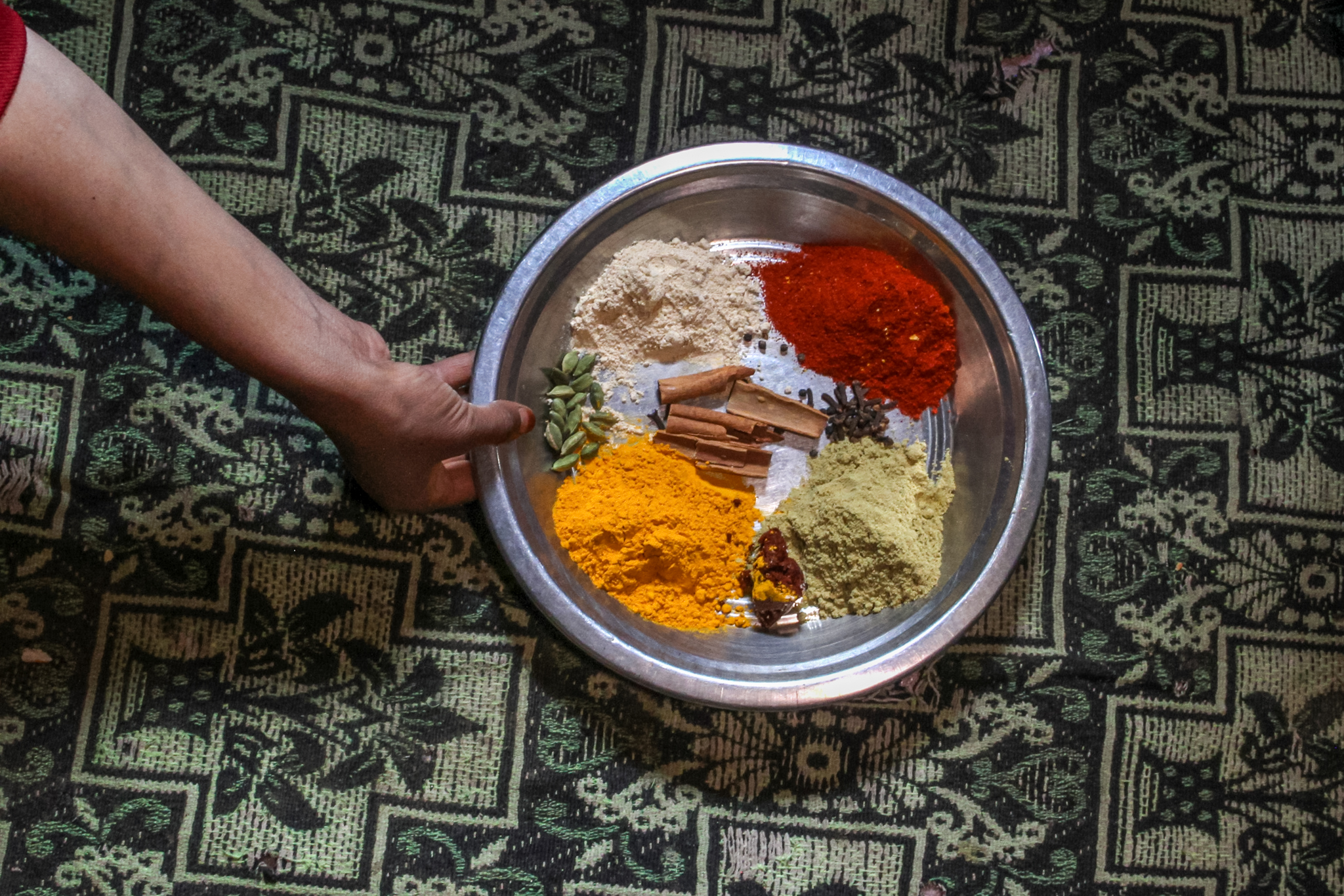 Shaheena prepares spices to add to the gucchi morels to finish the dish