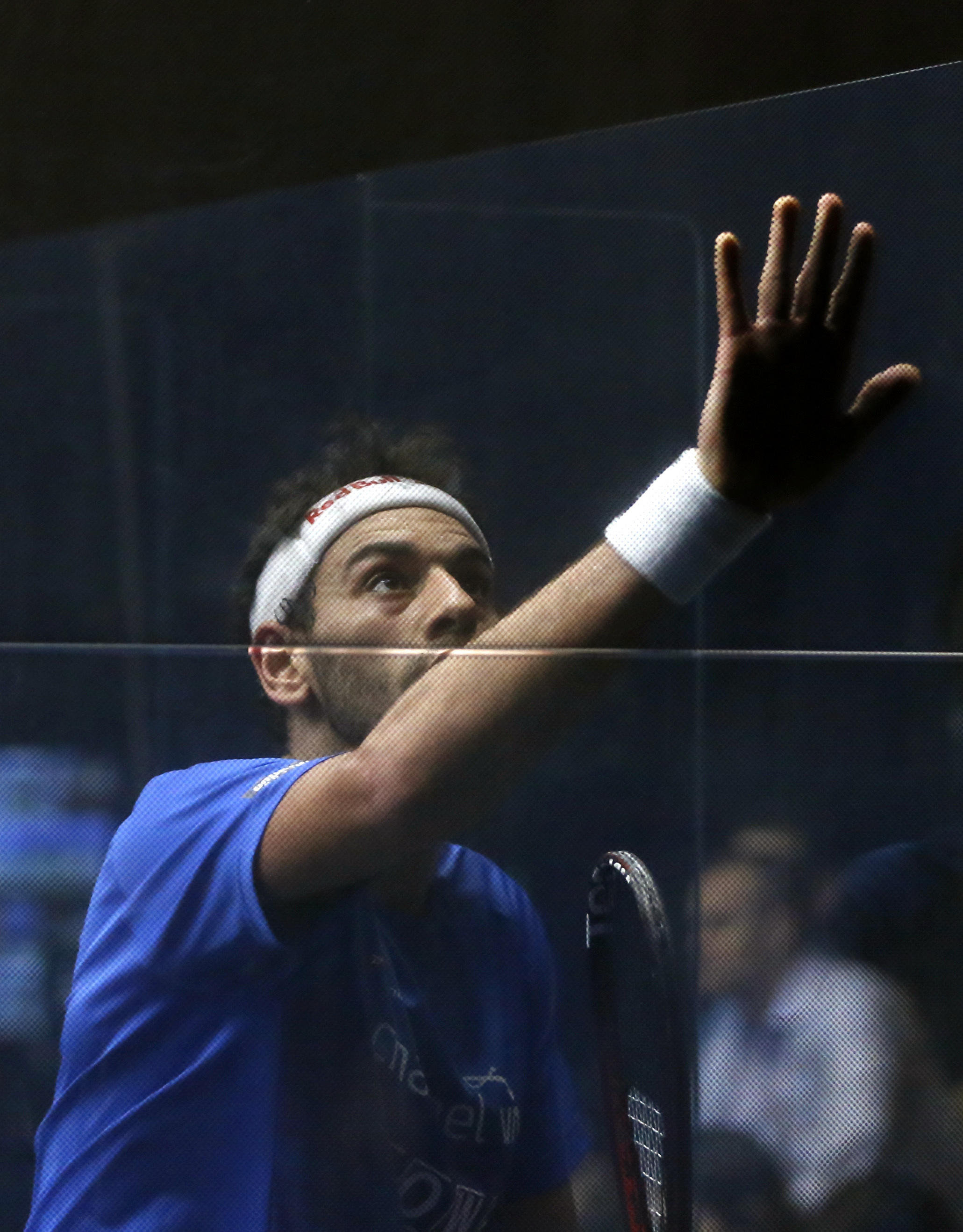 No. 1 seeded player Mohamed Elshorbagy wipes his sweaty hand and arm against the squash court glass wall during a 2017 Windy City Open squash tournament match against Cesar Salazar, from Mexico, at the University Club of Chicago in Chicago [File photo: Charles Rex Arbogast/AP]