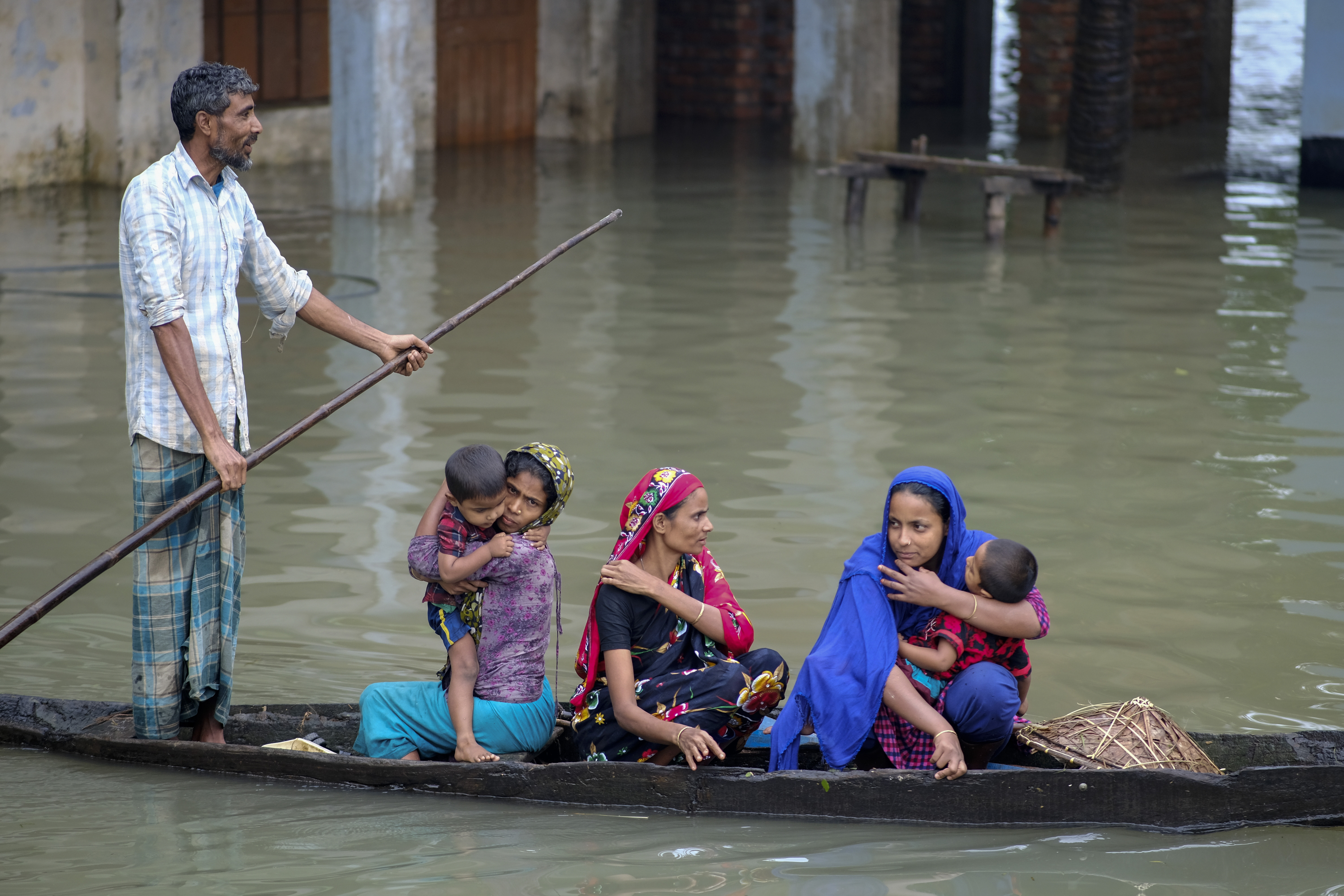 Flood-affected people ride on a boat in Sylhet, Bangladesh