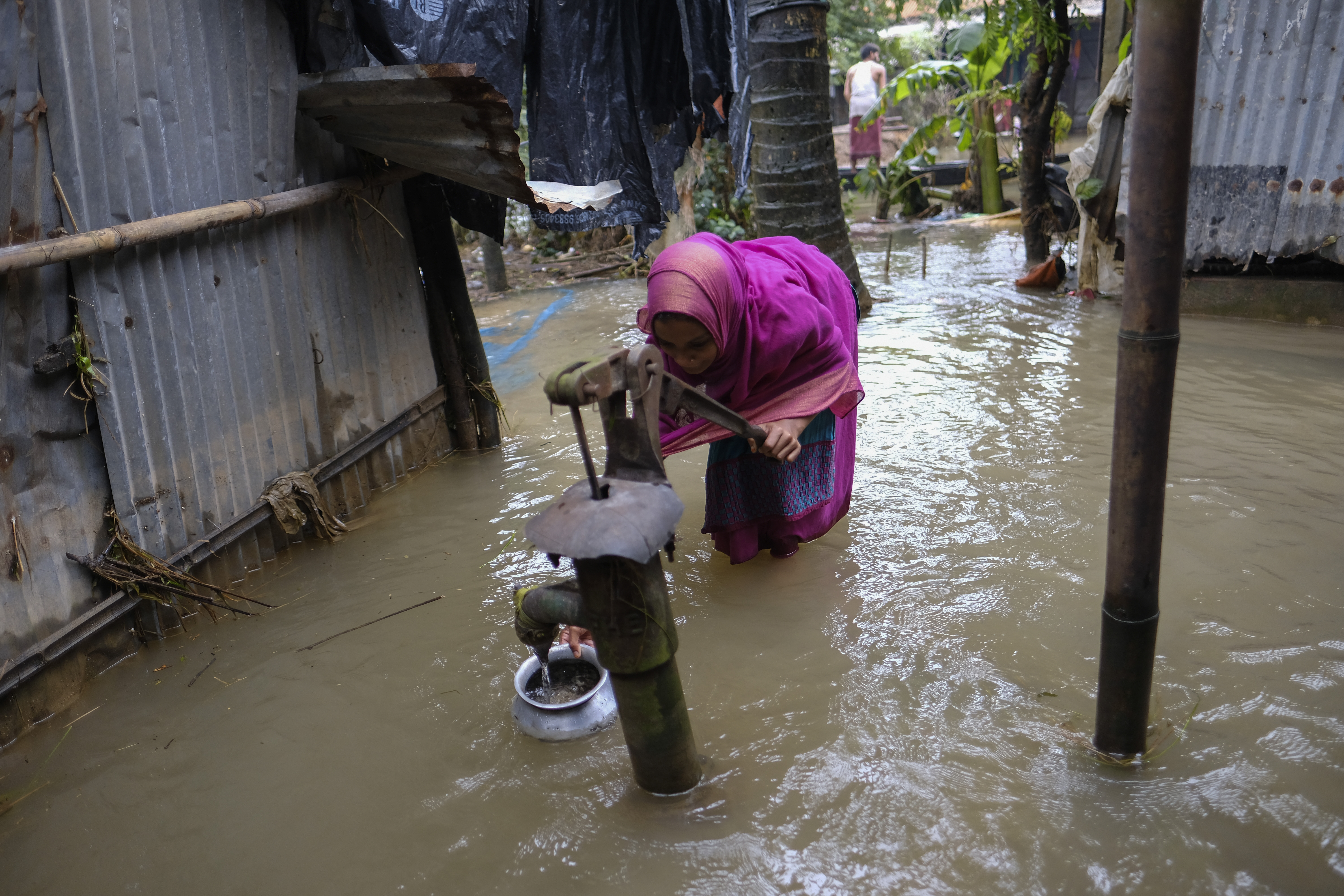 A flood-affected girl collects drinking water at Companiganj in Sylhet