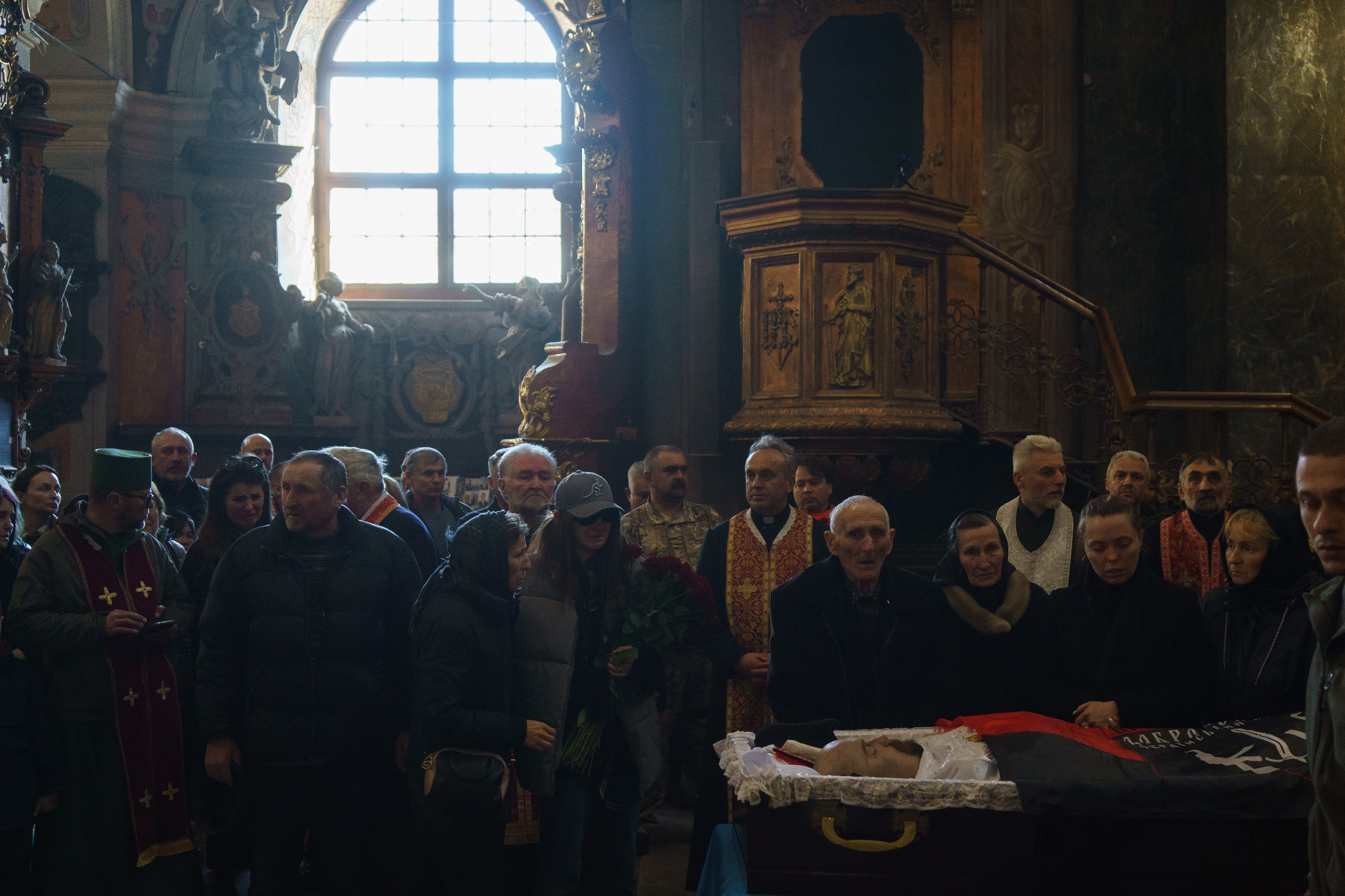 The funeral of a civilian military volunteer killed in action at a church in Lviv, western Ukraine.