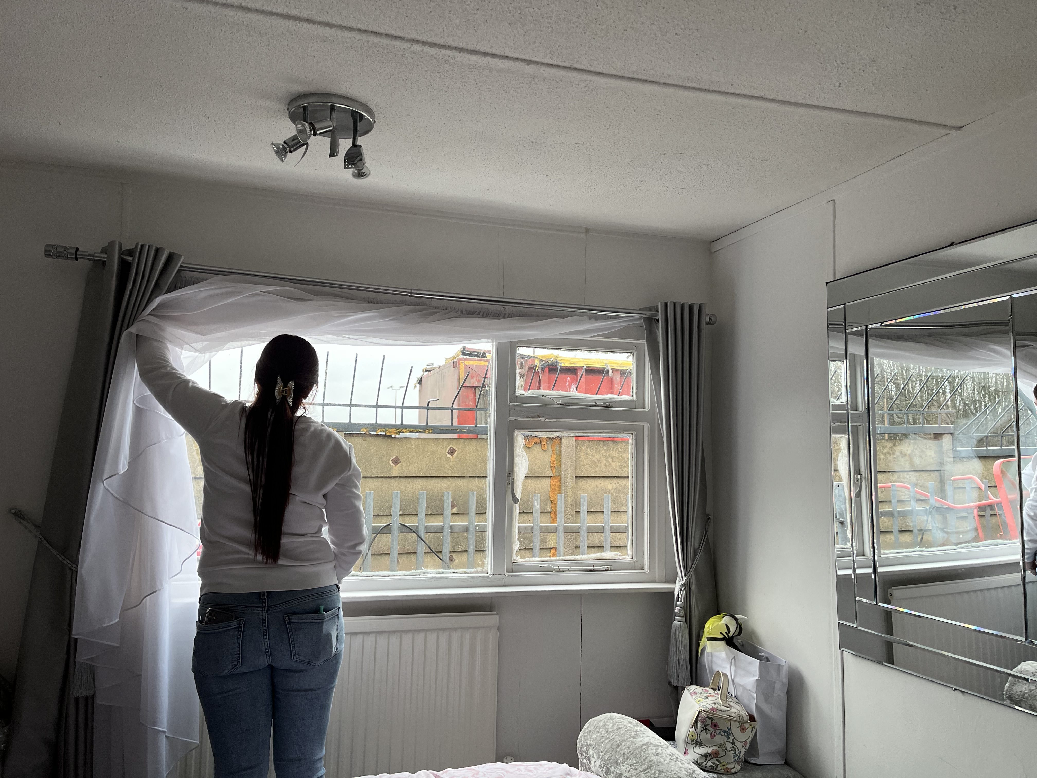 A woman looks out of a window