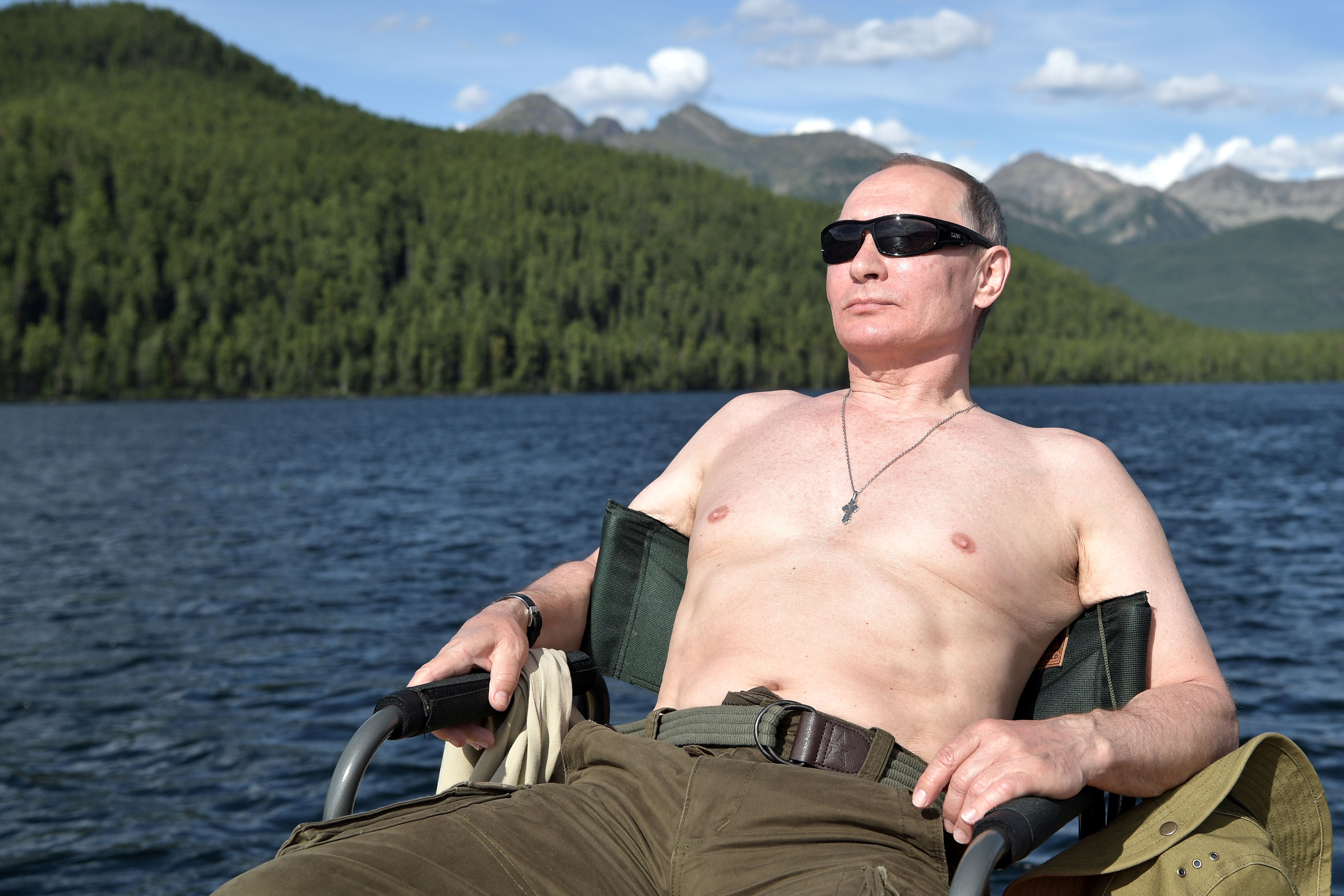 Russian President Vladimir Putin relaxes after fishing in southern Siberia
