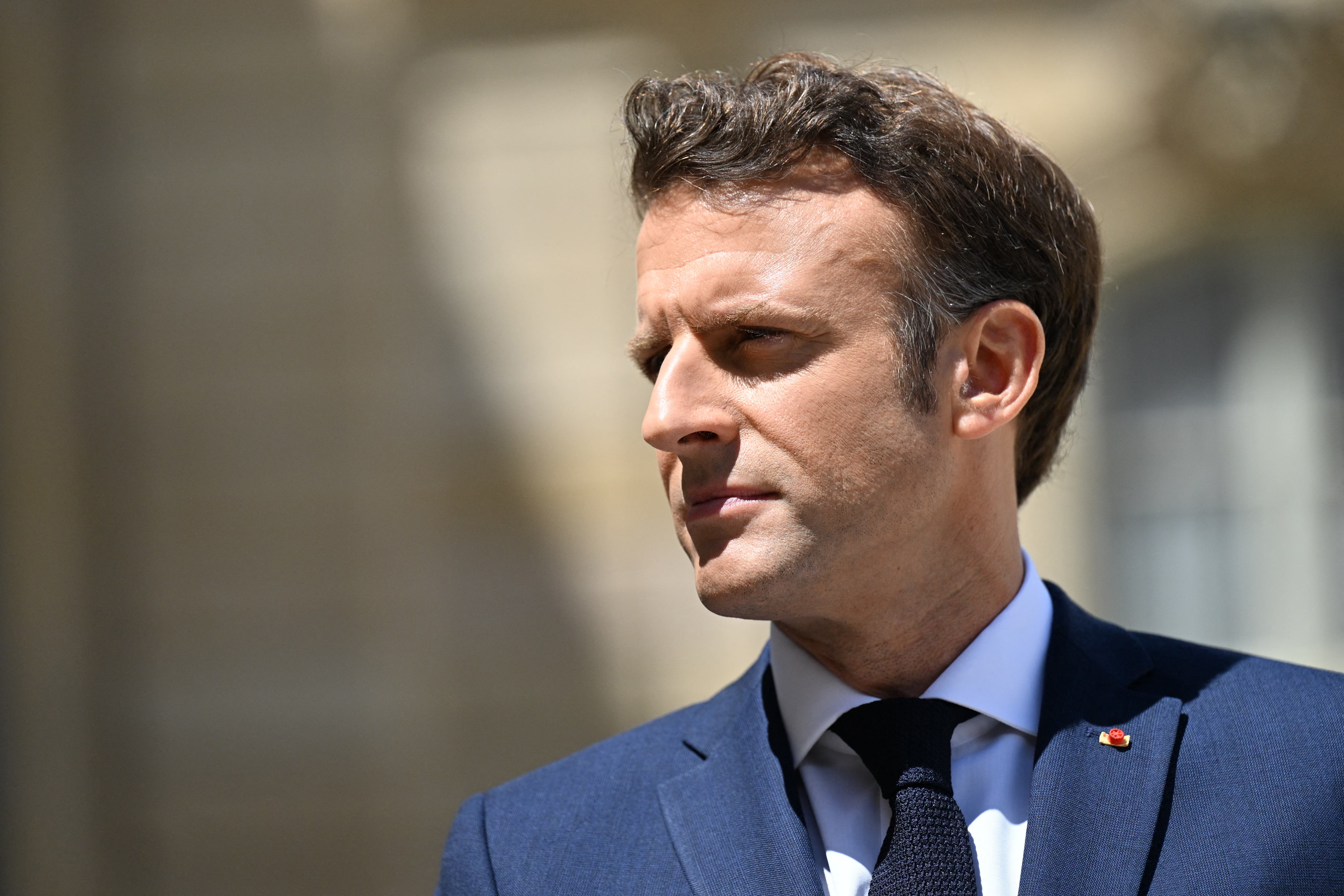 France's President Emmanuel Macron reacts as he welcomes Australia's Prime Minister prior to a working lunch at the presidential Elysee Palace.
