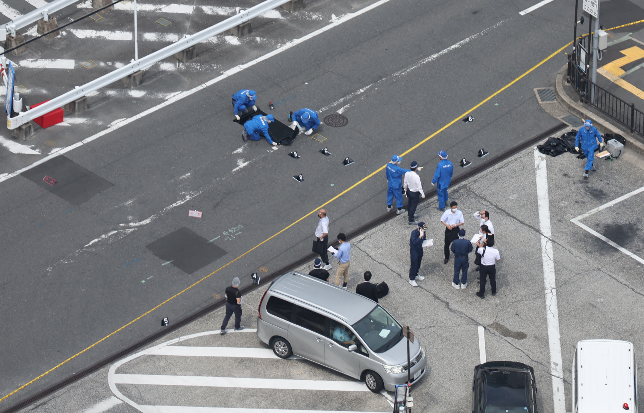 This aerial view taken from a helicopter chartered by Jiji Press shows police (C) working at the scene at Kintetsu Yamato-Saidaiji Station in Nara