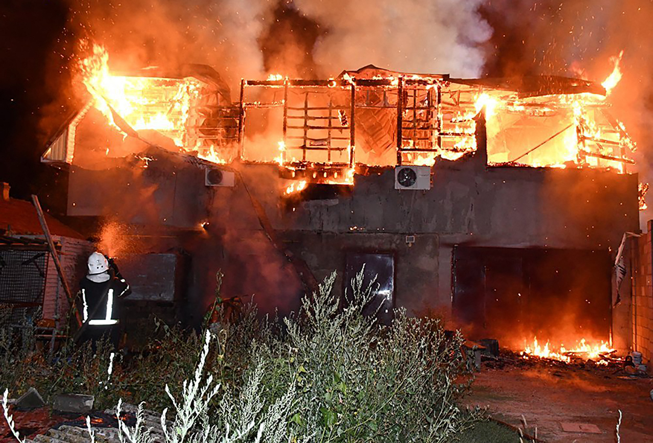 A firefighter facing a fire